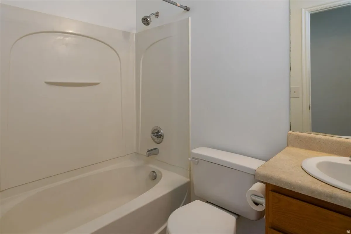Upstairs hallway bath featuring vanity and washtub / shower combination