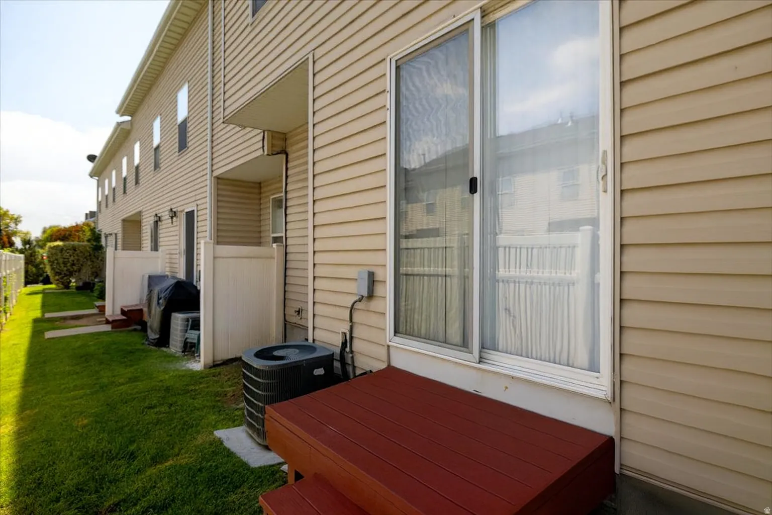 Back of home with a wooden deck and patio door to dining/kitchen
