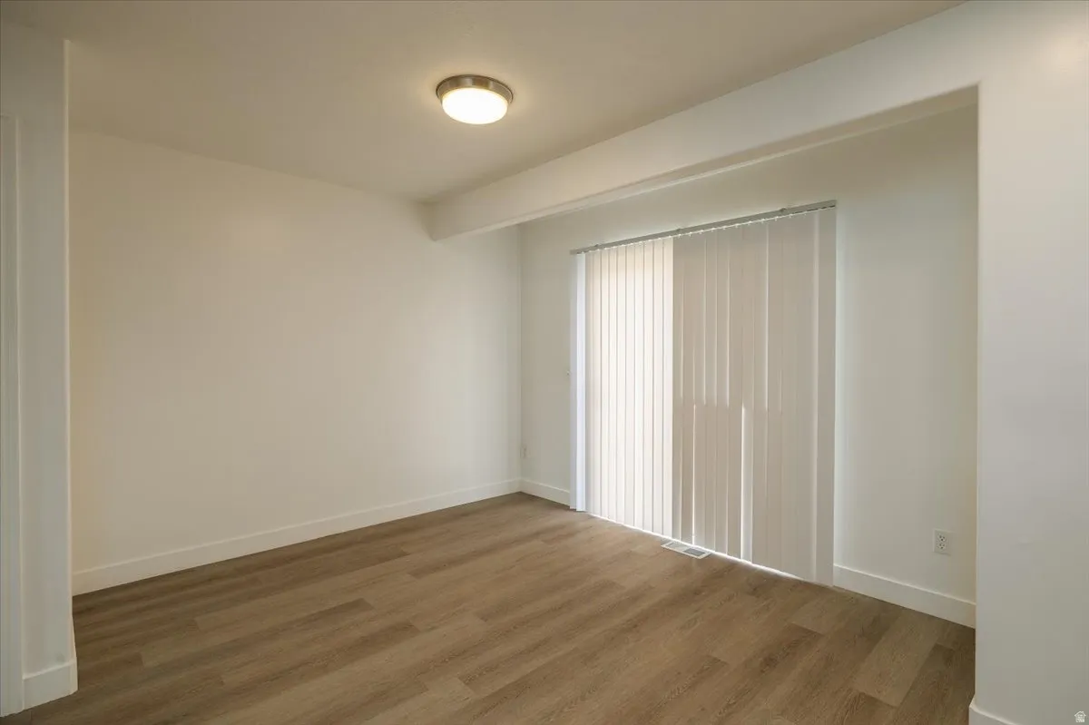 View of dining area and back patio door from kitchen