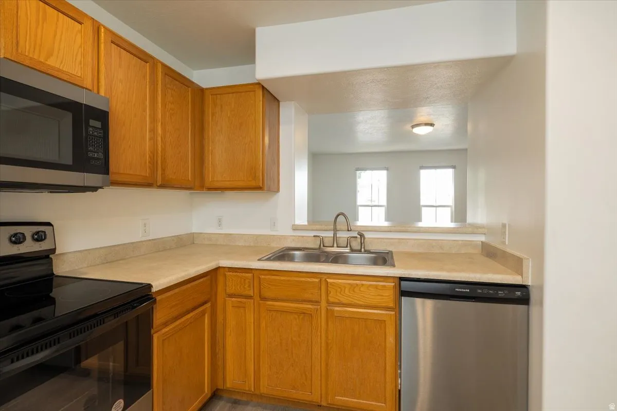 View of kitchen out to living room