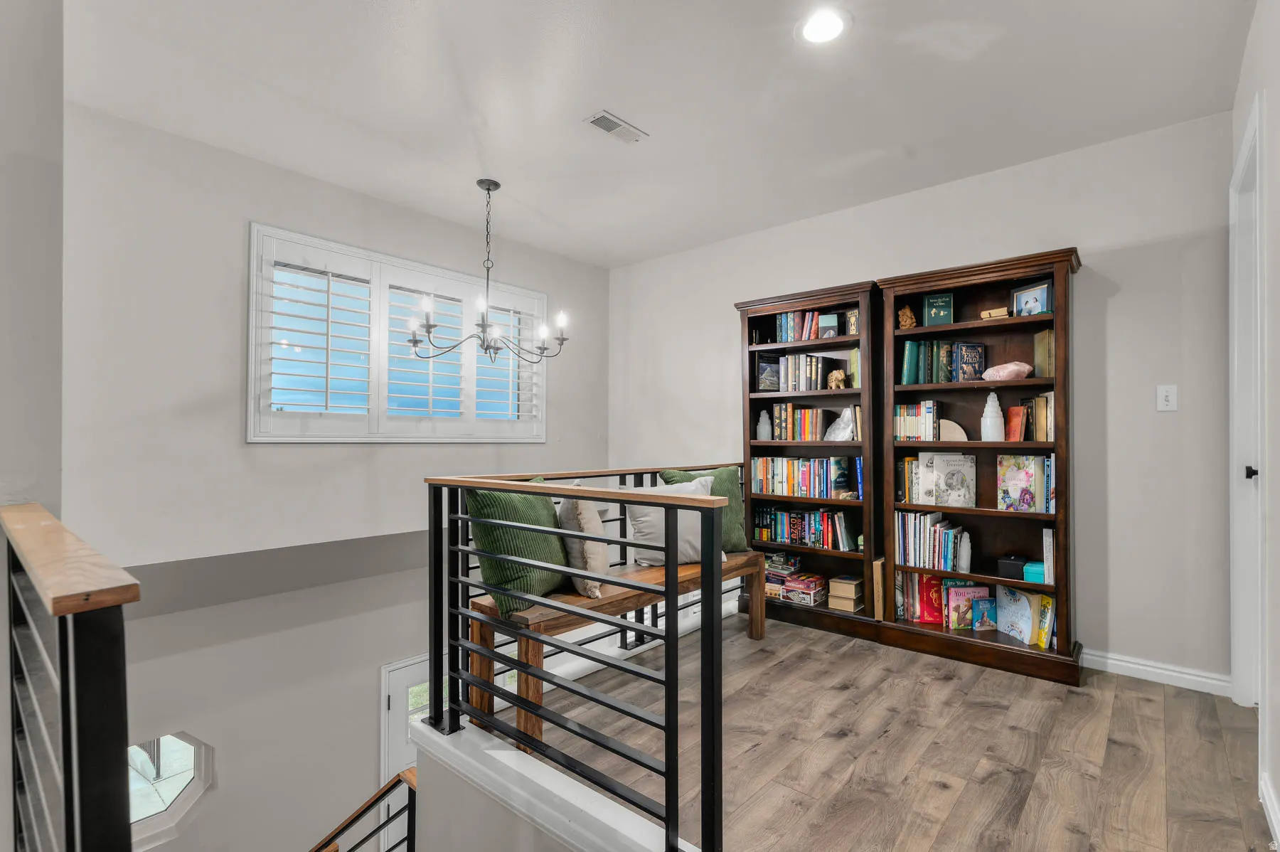 Staircase featuring wood finished floors, a chandelier, and recessed lighting