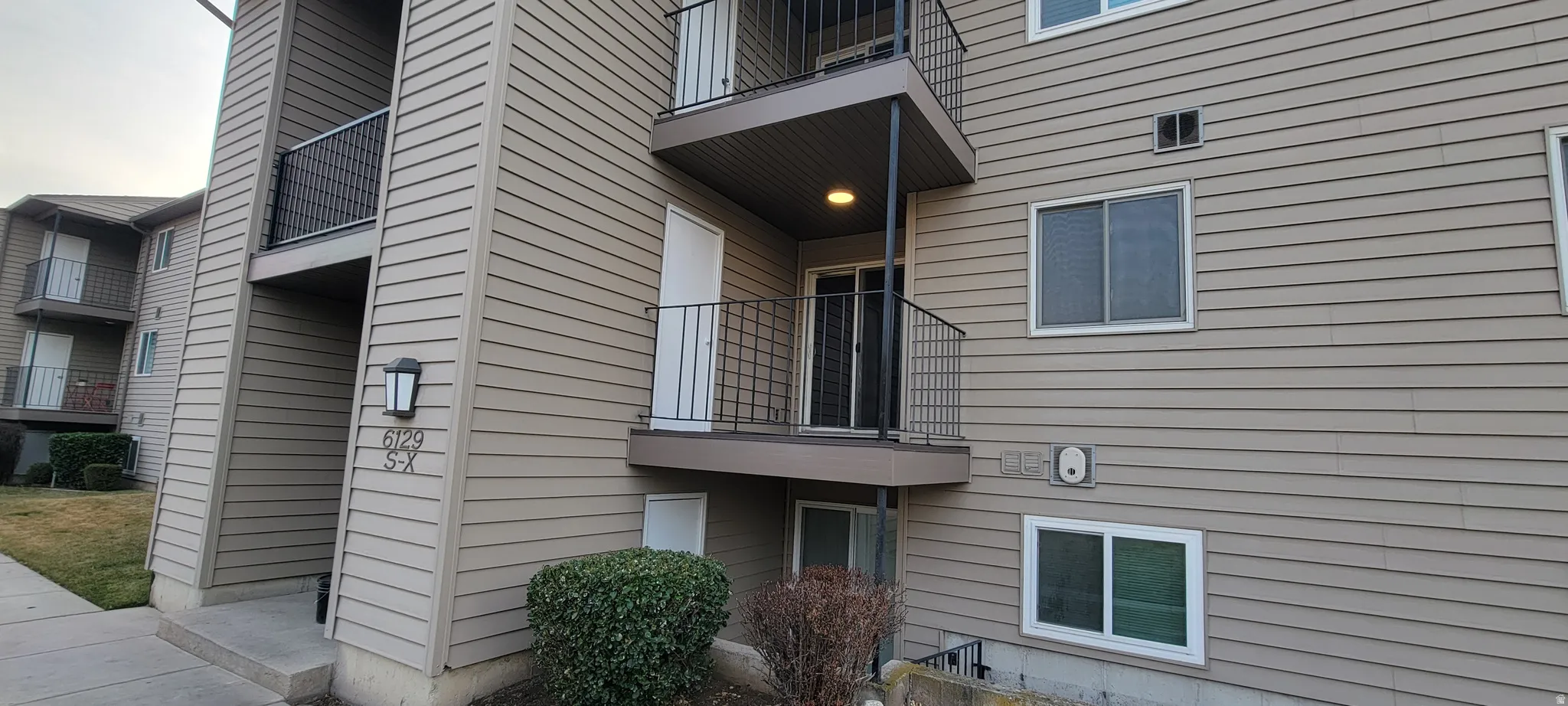 View of property exterior featuring a balcony