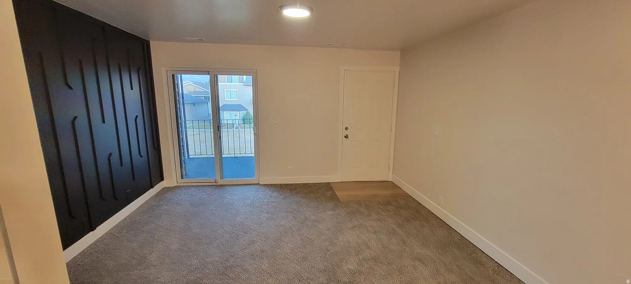 Carpeted spare room with baseboards