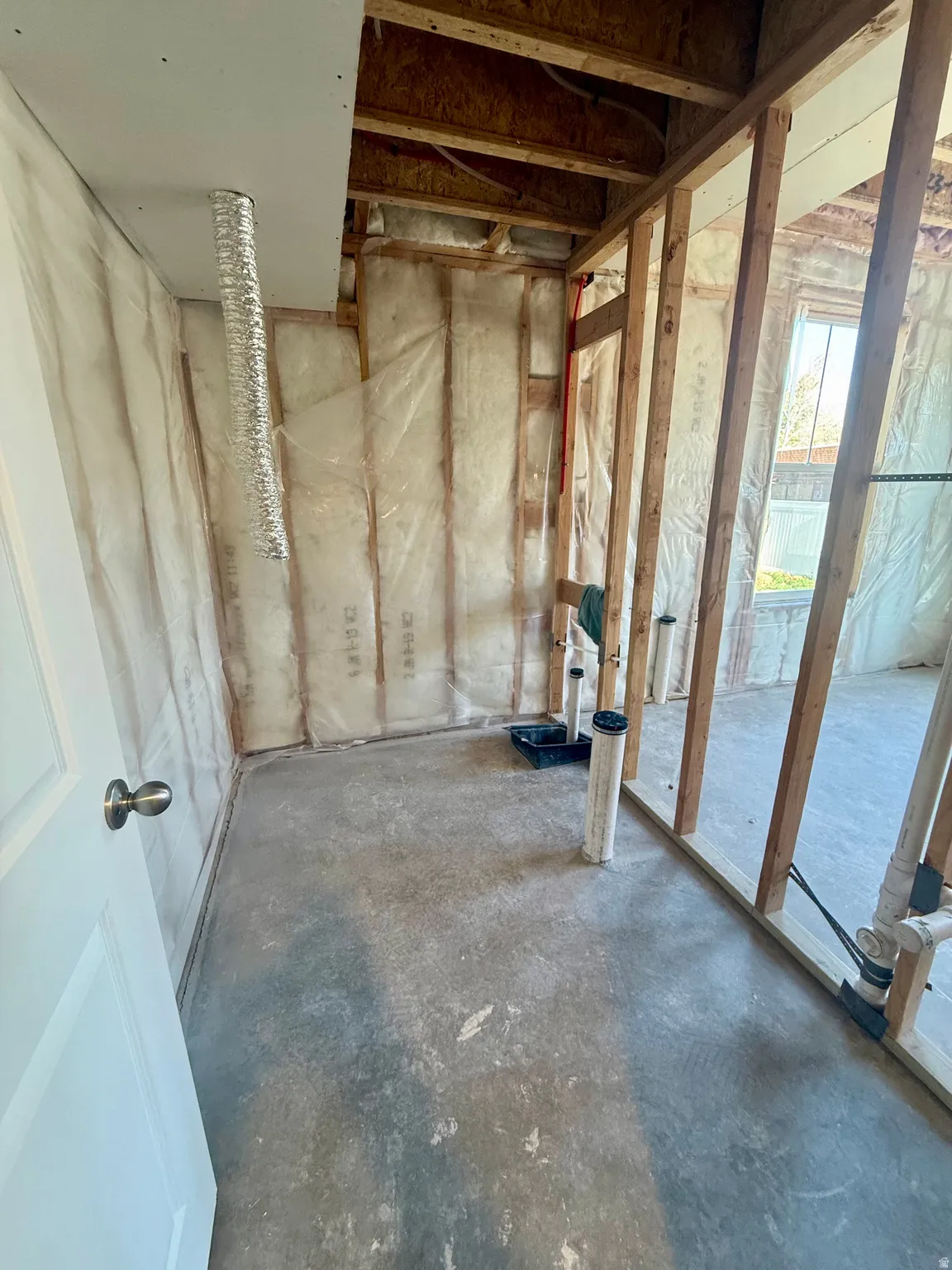 Misc room featuring unfinished concrete floors