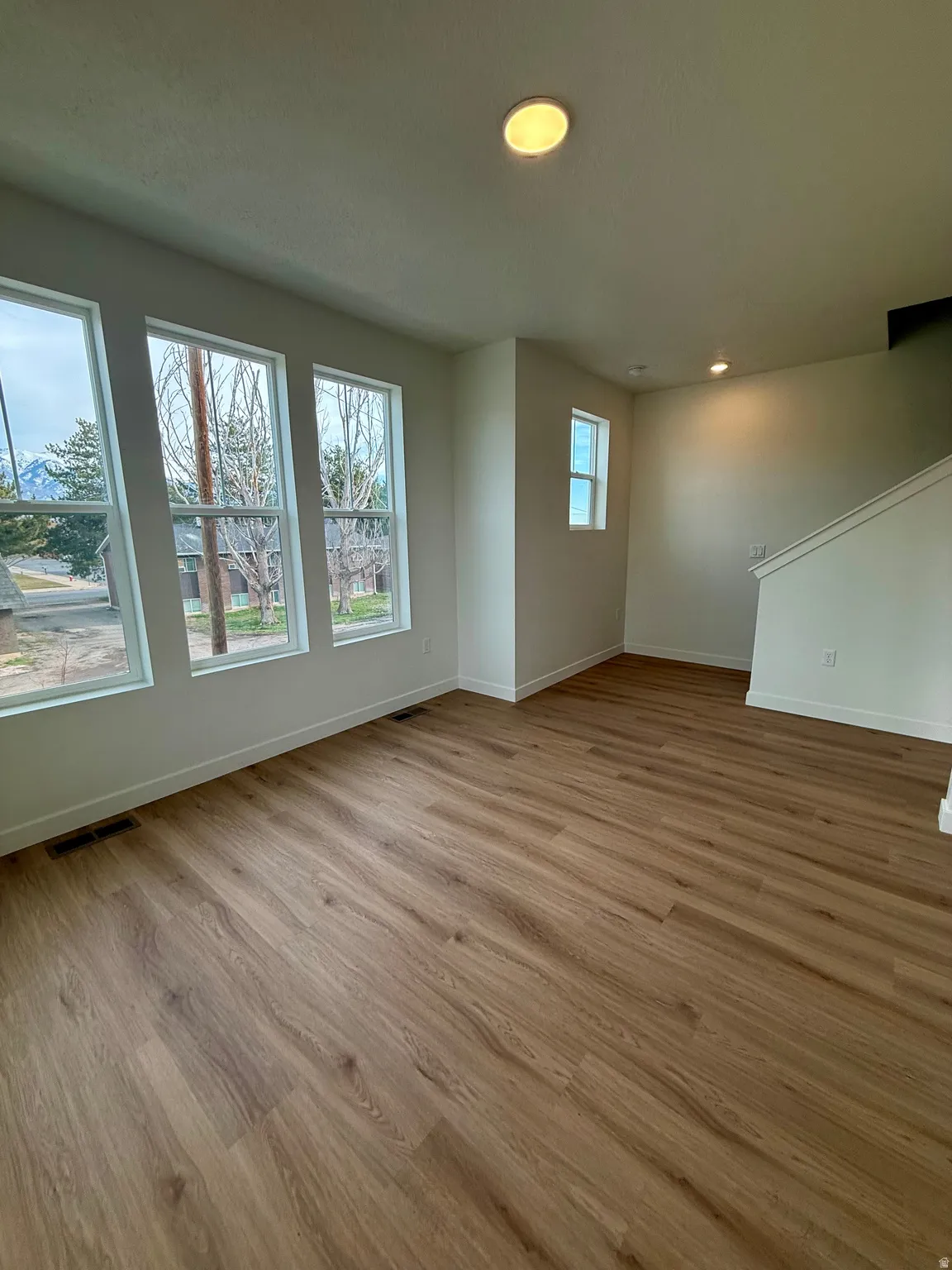 Spare room featuring light wood finished floors and recessed lighting