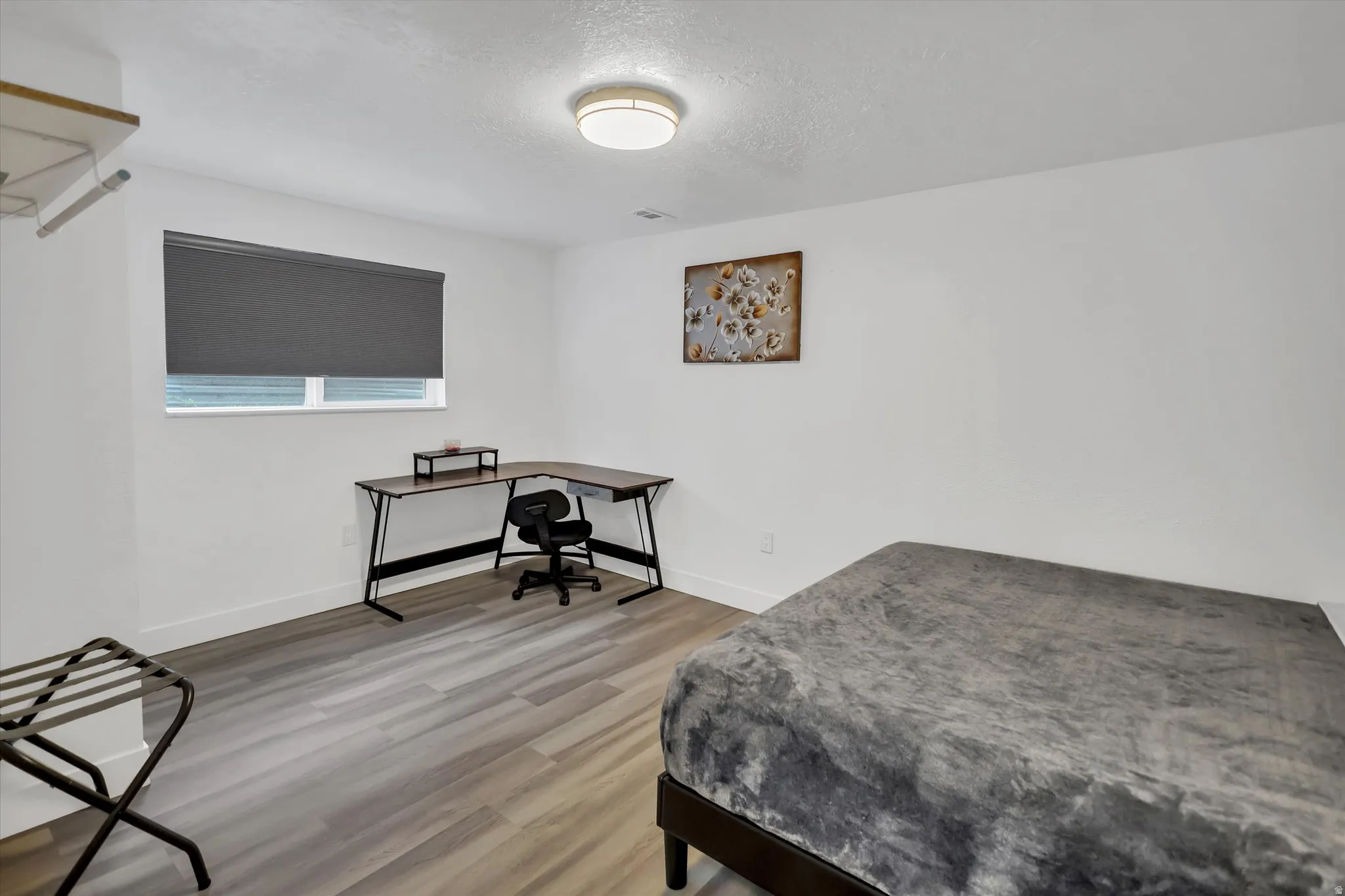 Bedroom featuring a textured ceiling and light wood-style flooring