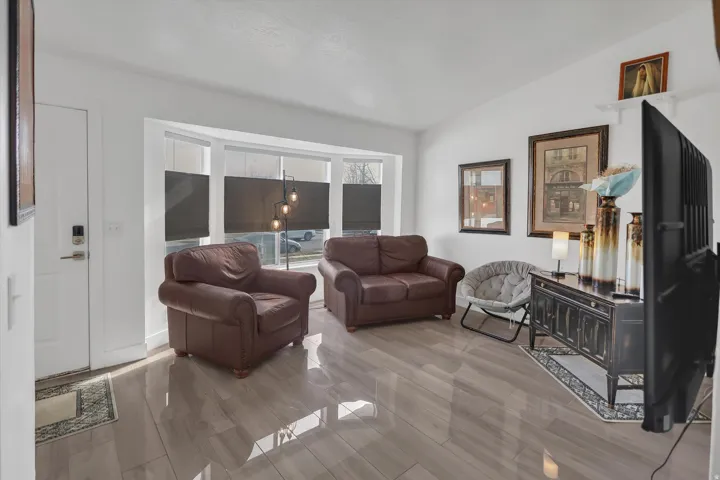 Living room featuring lofted ceiling and wood finish floors