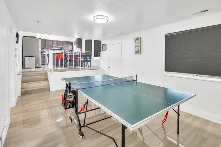 Recreation room featuring a textured ceiling and light wood finished floors
