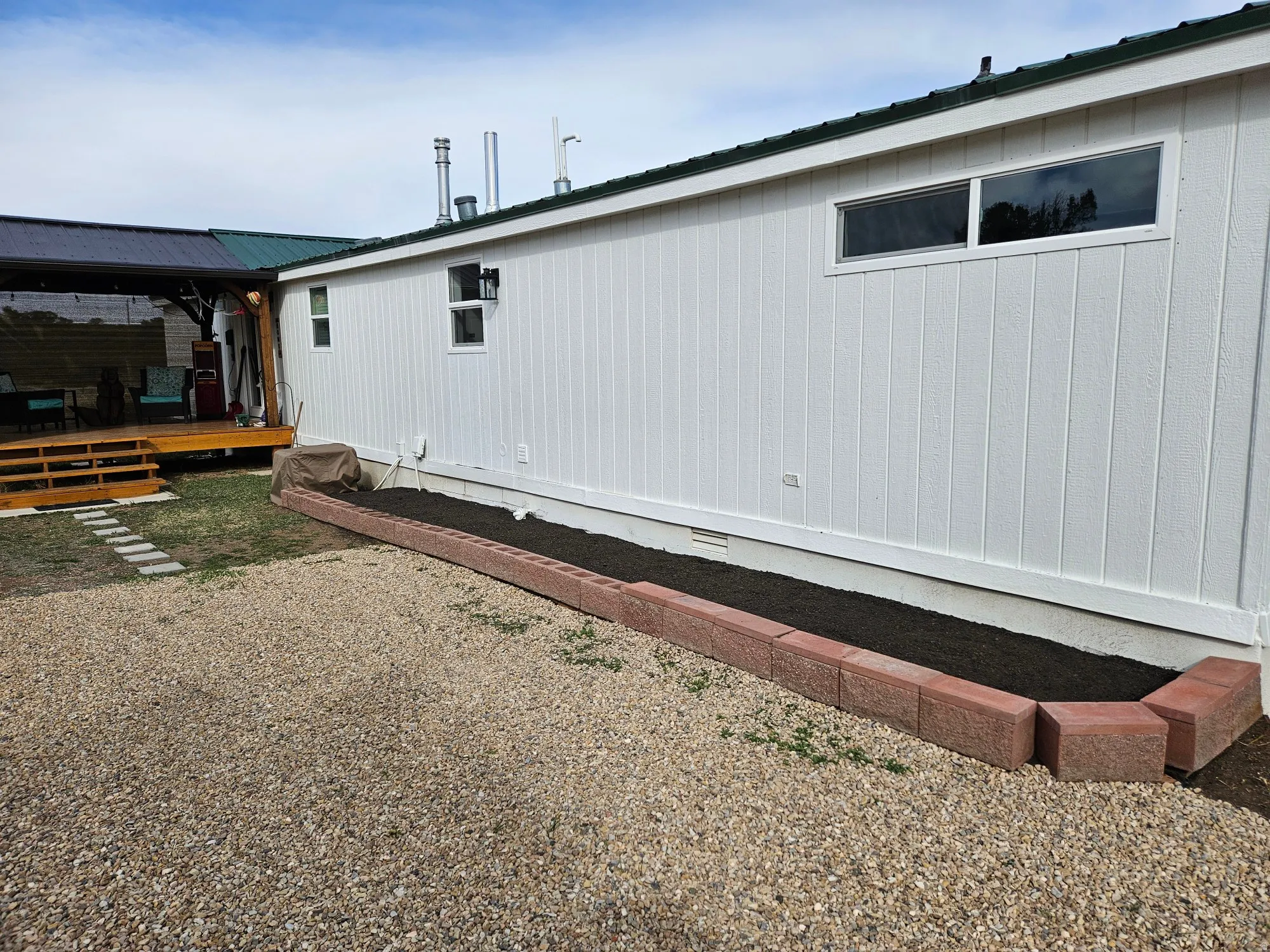 View of side of property featuring a wooden deck