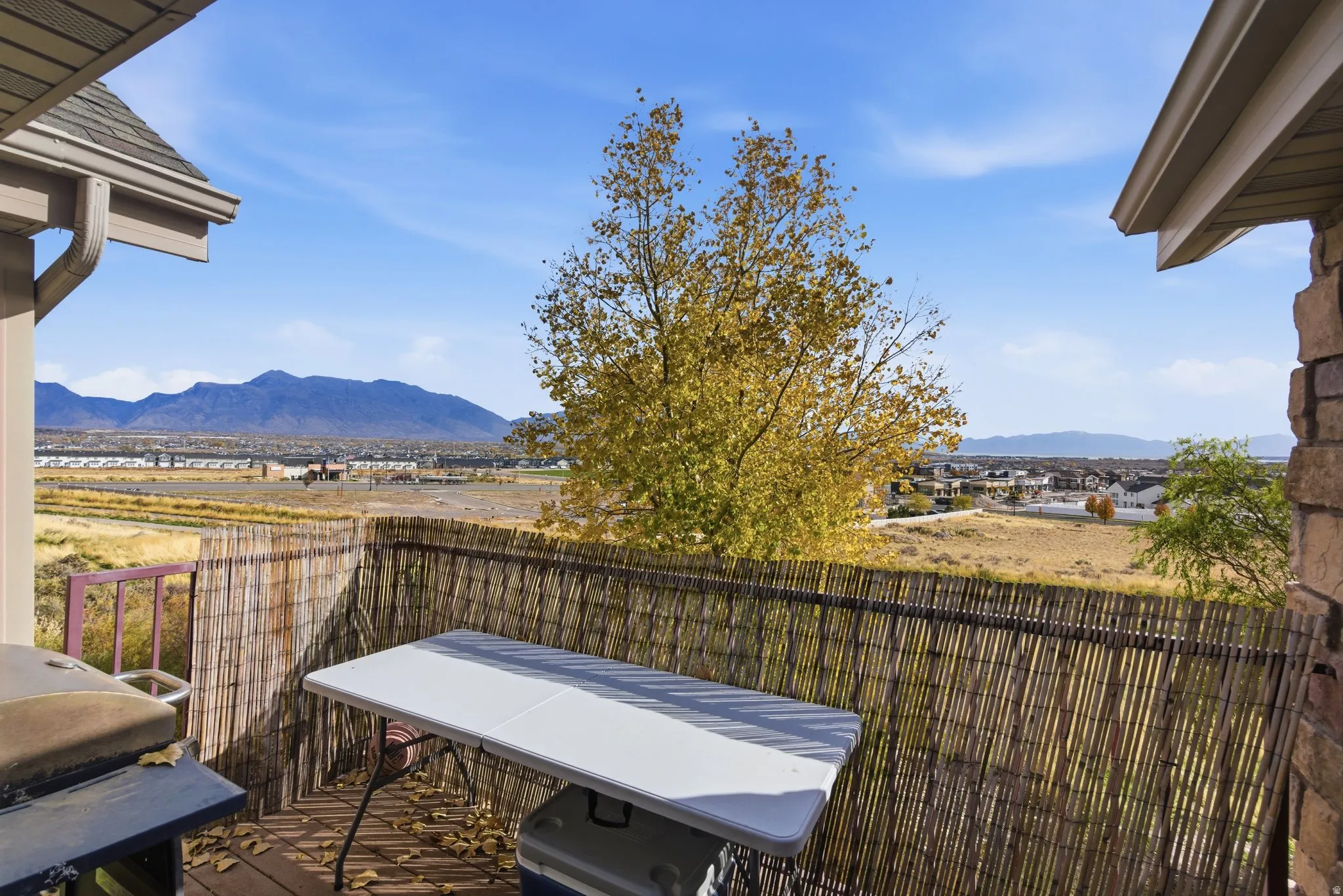 Wooden deck with a mountain view and grilling area