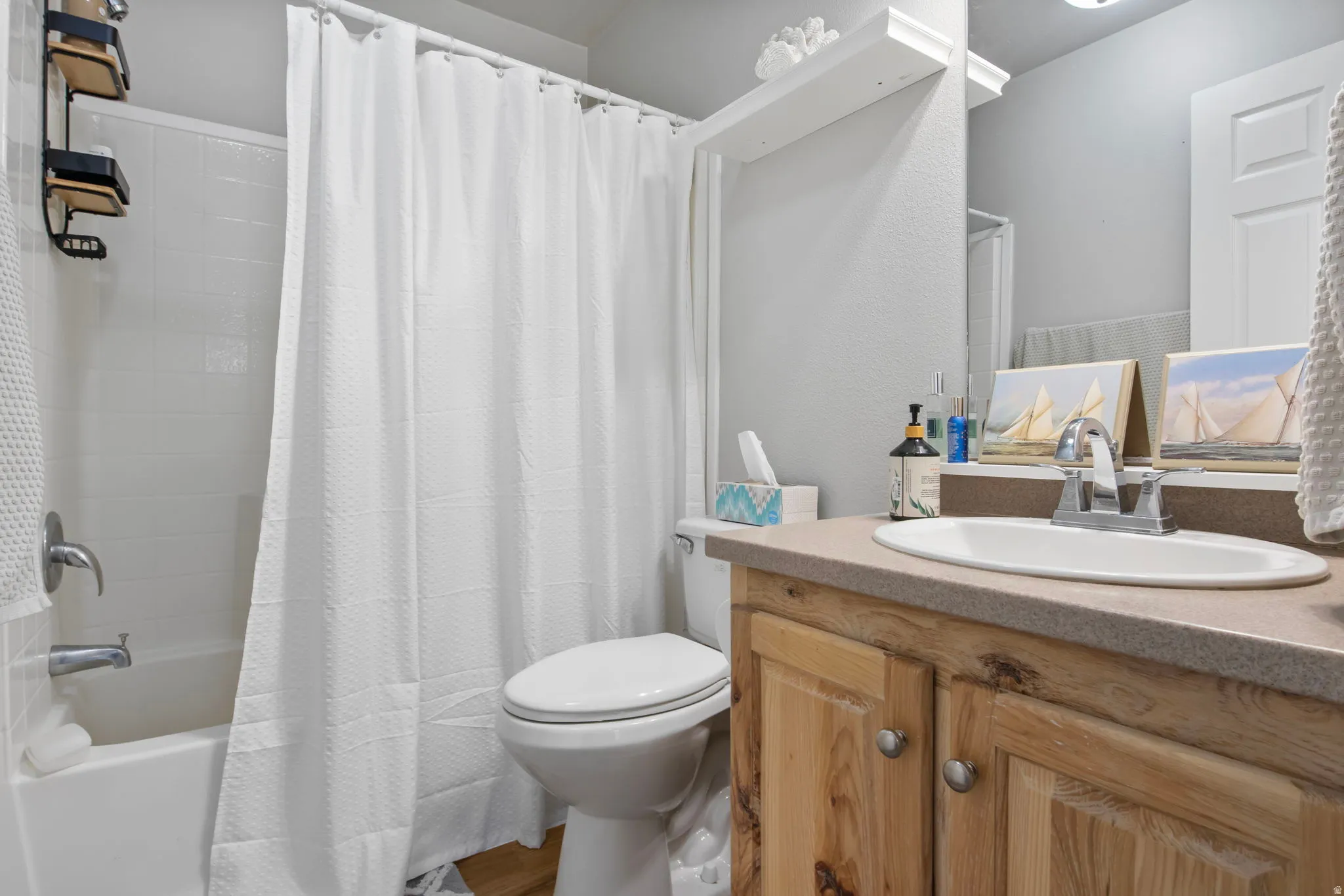 Bathroom featuring vanity and shower / tub combo with curtain