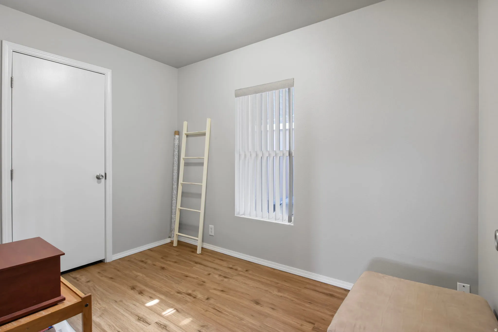 Living area featuring light wood-style flooring and baseboards