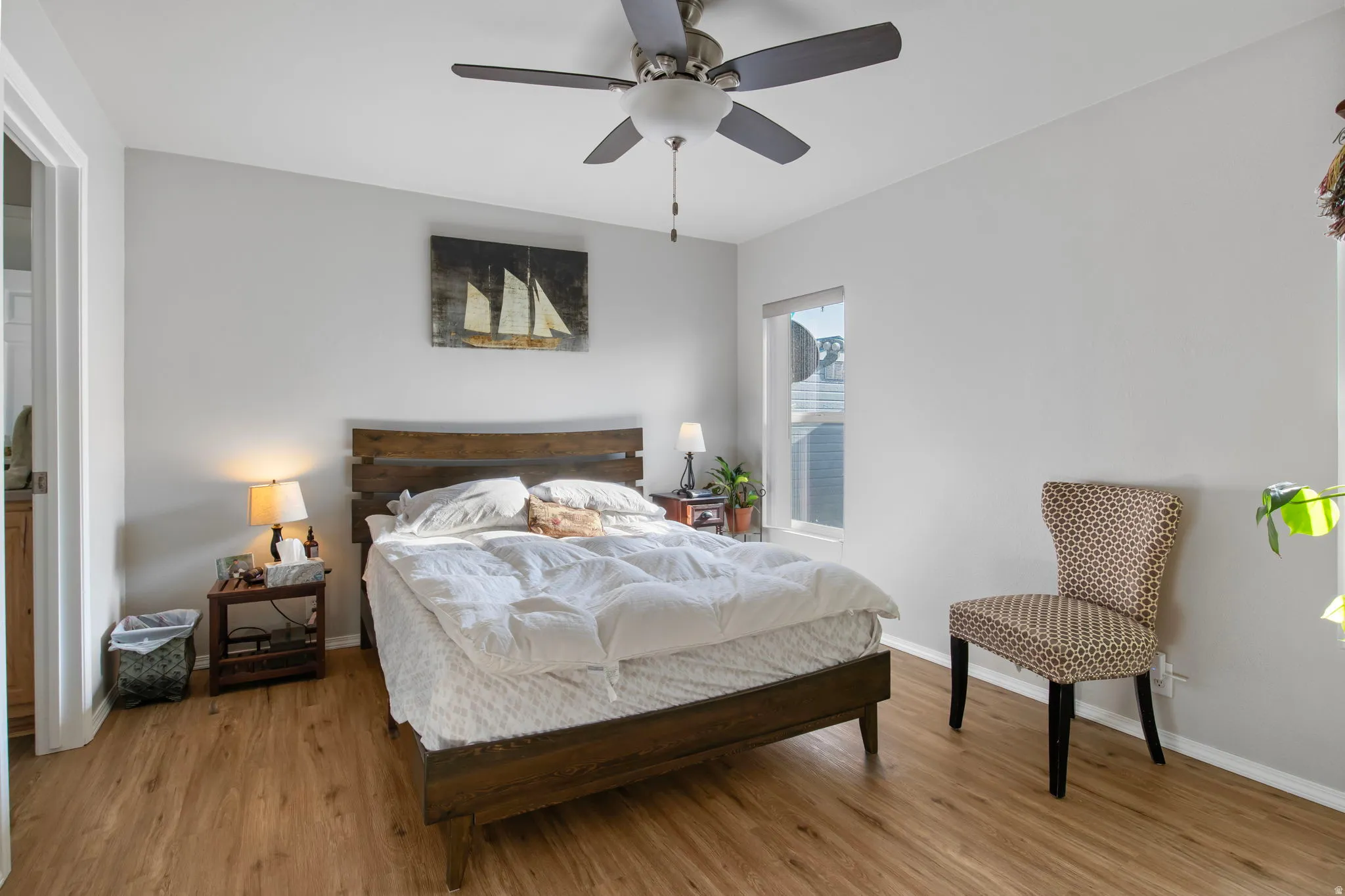 Bedroom featuring wood finished floors and a ceiling fan