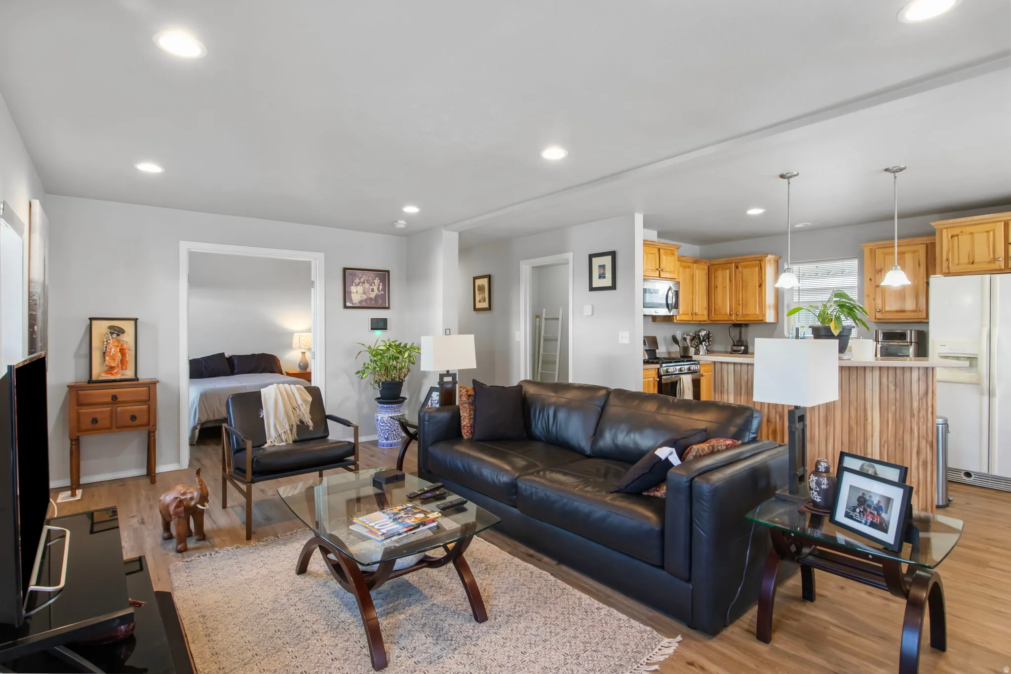 Living room with recessed lighting and light wood-style floors
