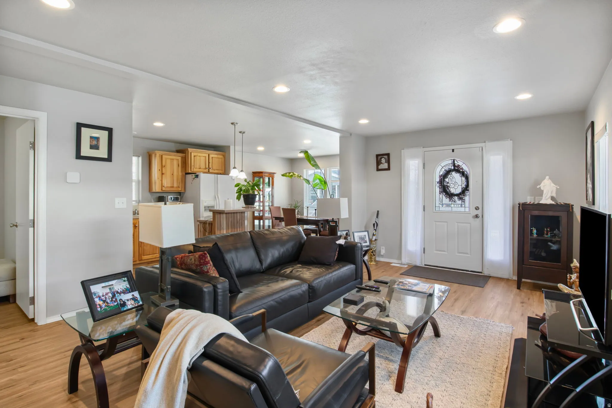 Living room featuring light wood finished floors and recessed lighting