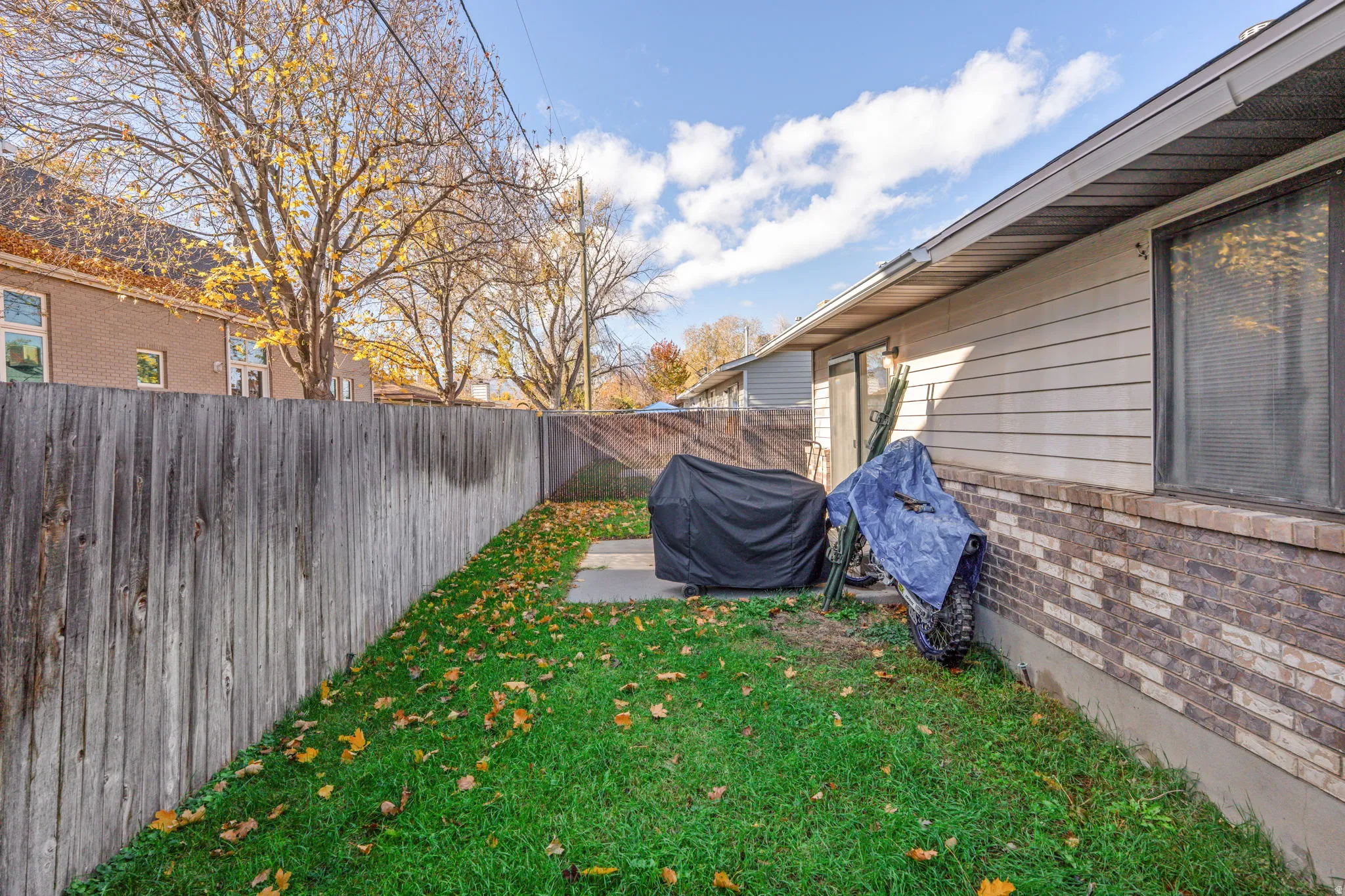Fenced backyard with a patio
