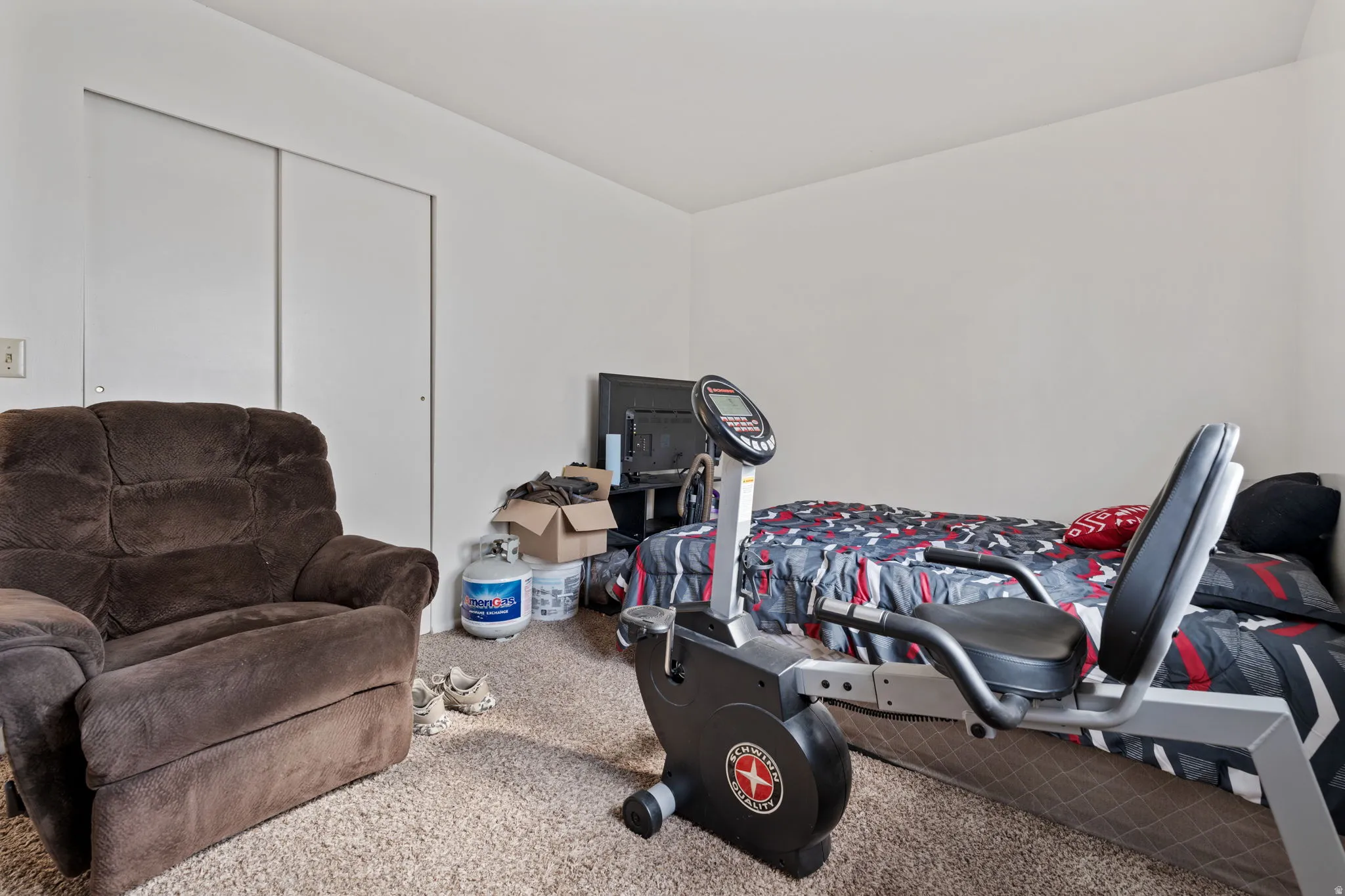 Carpeted bedroom with a closet