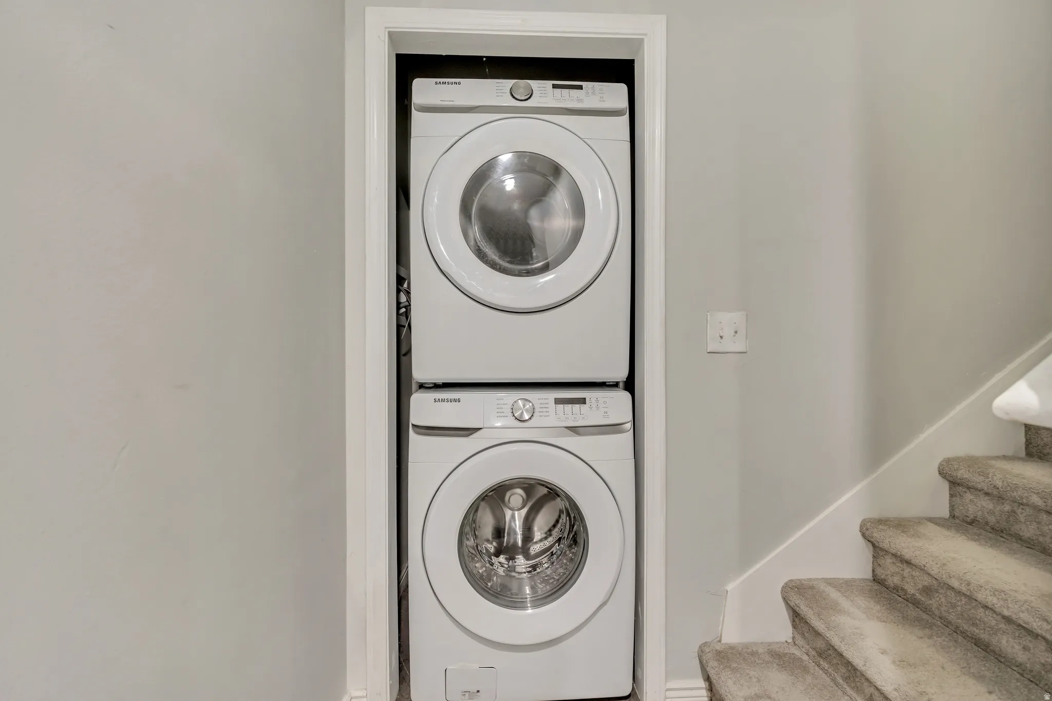 Laundry area featuring stacked washer / dryer