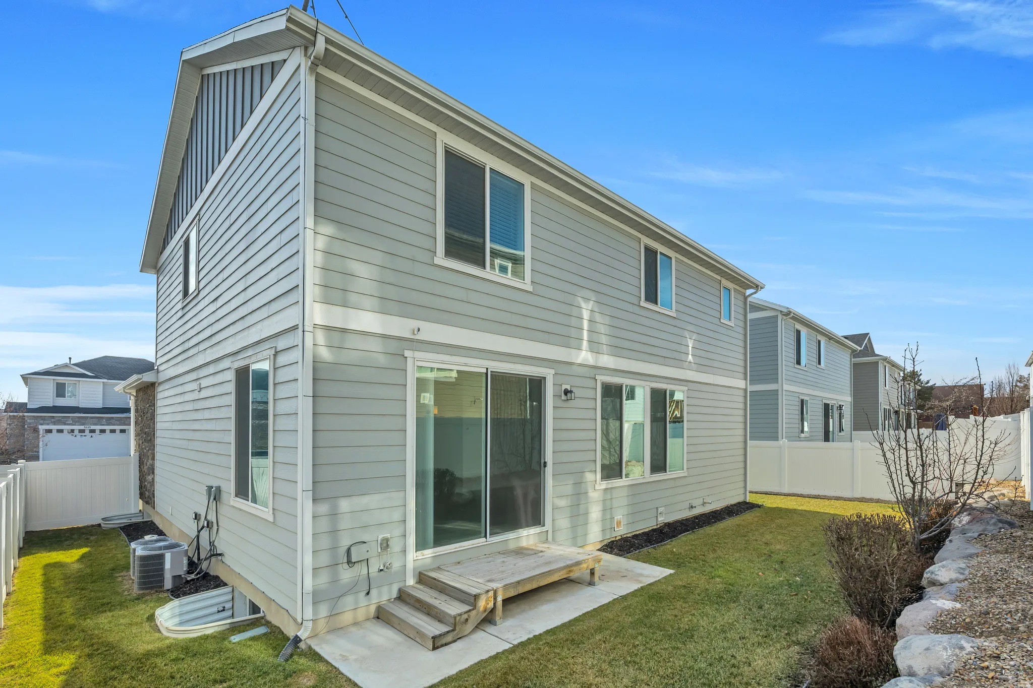 Rear view of house featuring a fenced backyard and entry steps