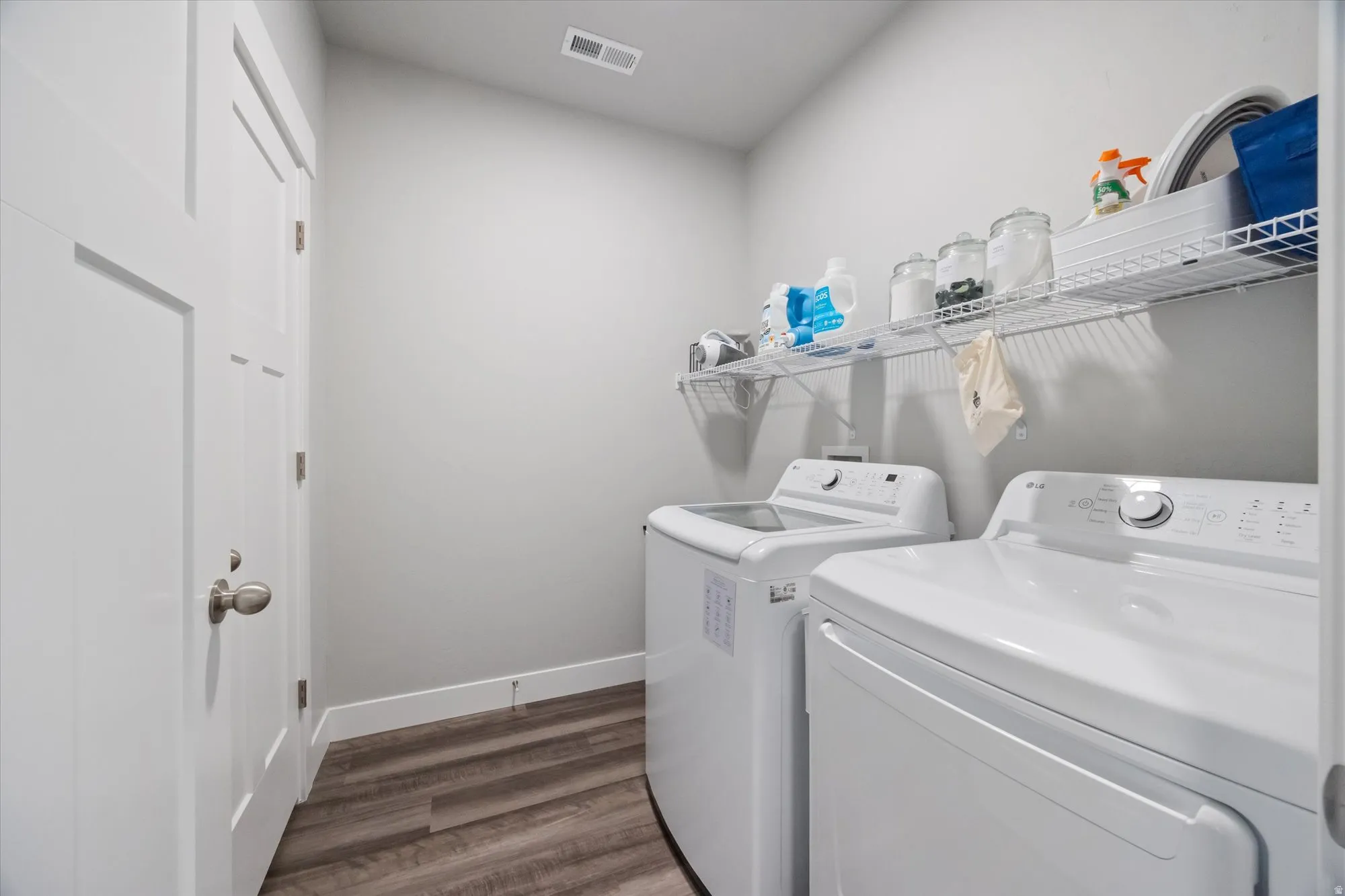 Washroom featuring independent washer and dryer and dark wood-style floors