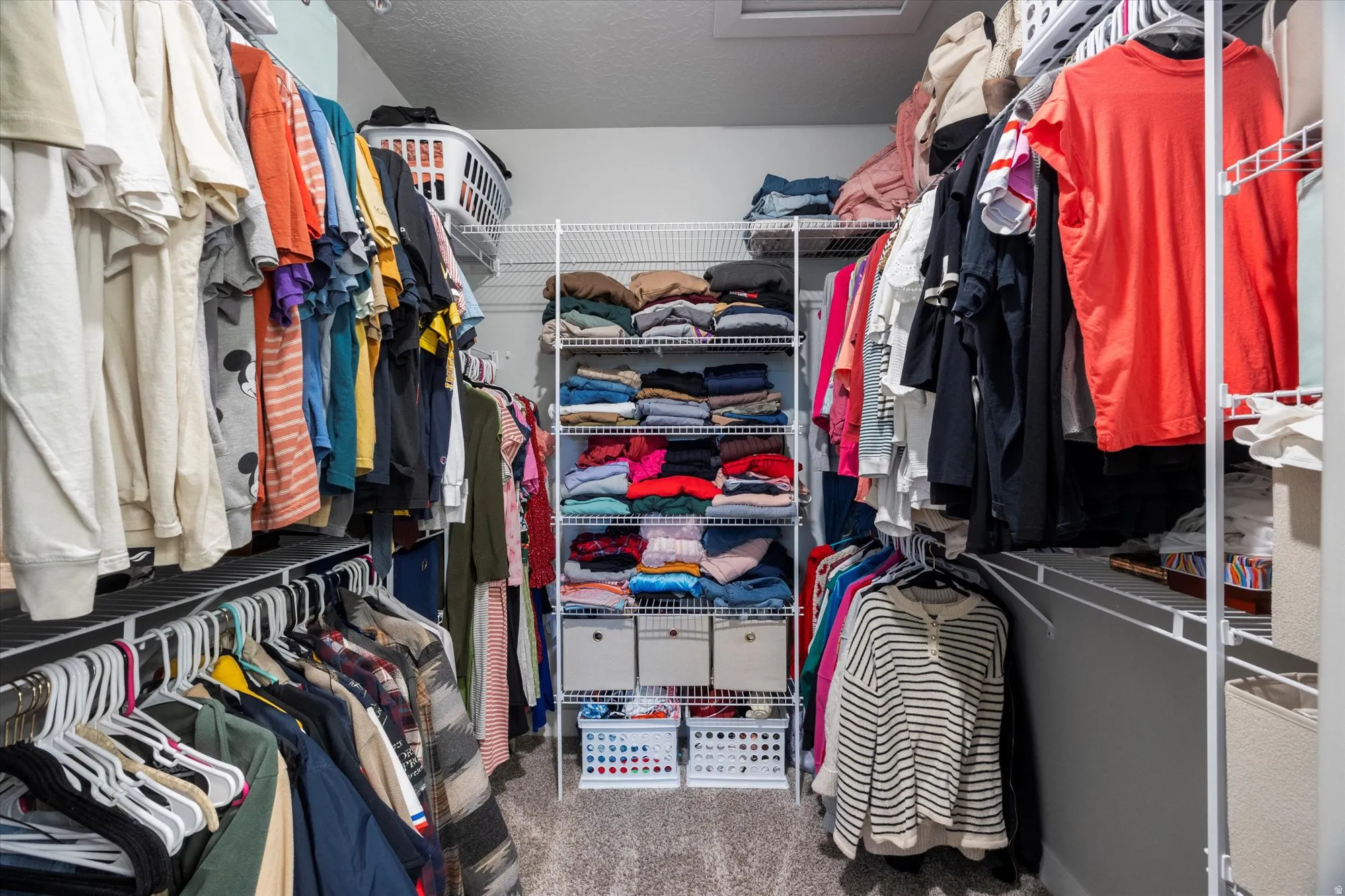 Spacious closet with light colored carpet