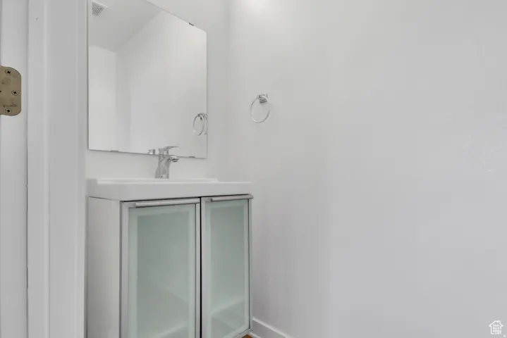 Bathroom with vanity and baseboards