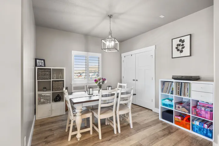 Dining room with wood finished floors and a chandelier