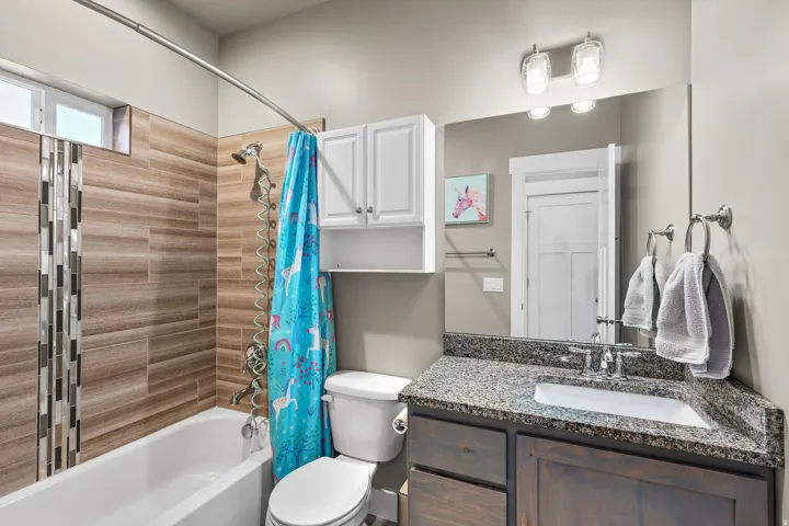 Bathroom featuring shower / tub combo with curtain and vanity