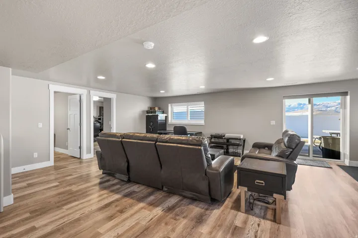Living room featuring recessed lighting, a textured ceiling, and light wood-type flooring