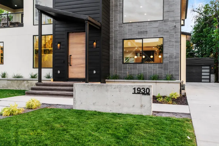 View of exterior entry featuring a yard and a garage