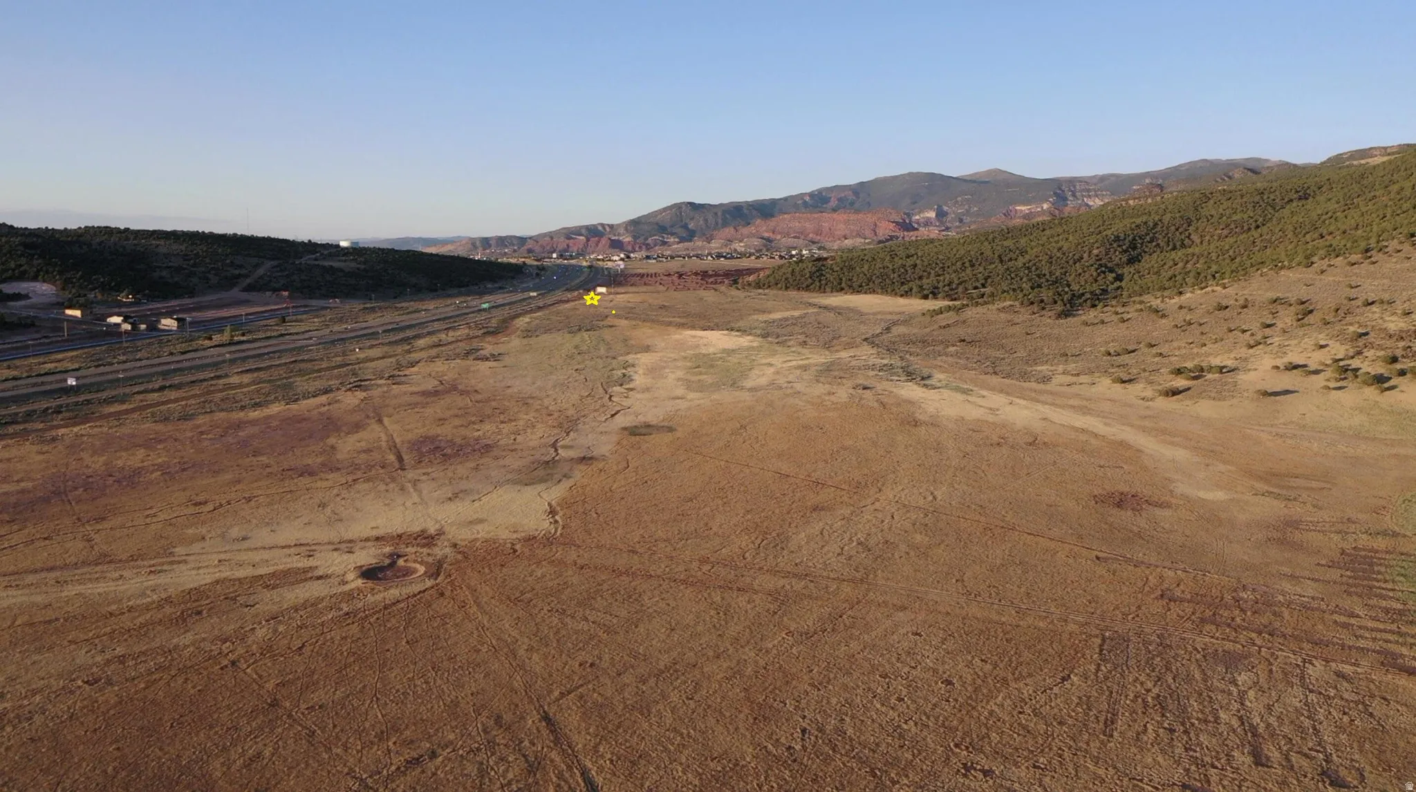 View of dirt / gravel road with a mountain view and a view of rural / pastoral area