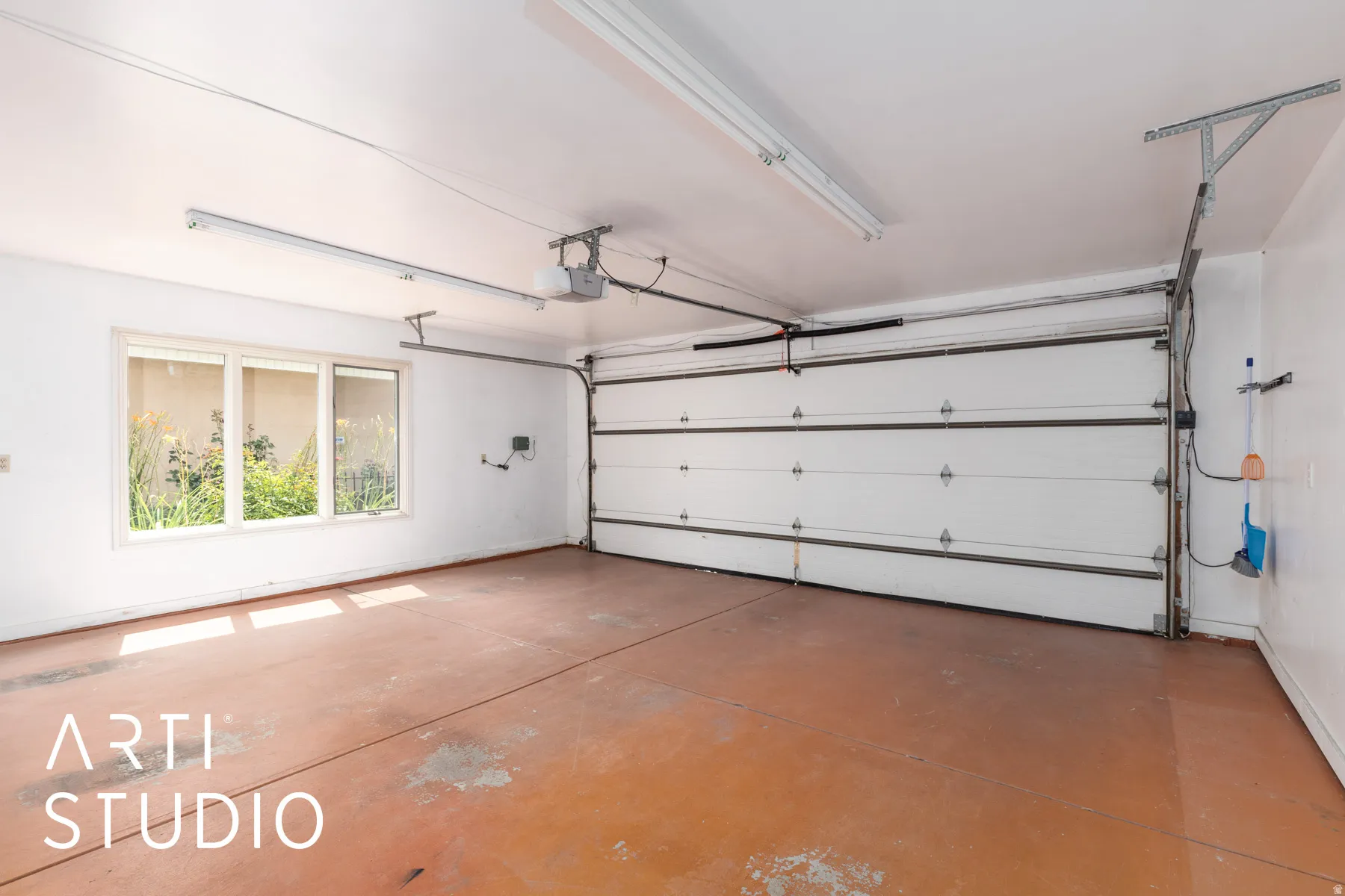 Garage featuring a garage door opener