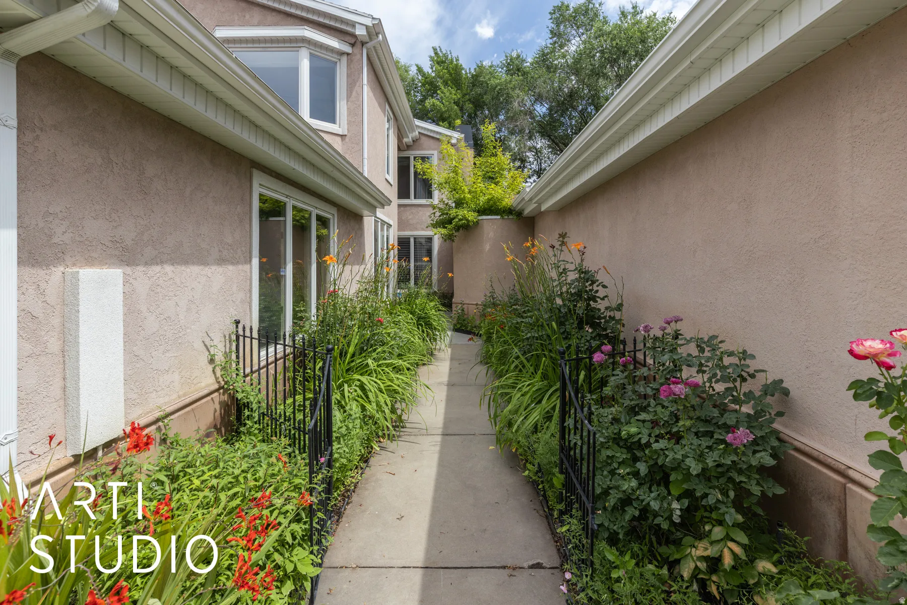 Traditional-style house featuring an attached garage, stucco siding, concrete driveway, and a front yard