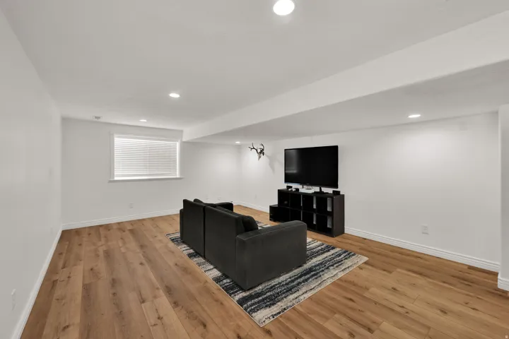 Living room featuring light wood-style flooring and recessed lighting
