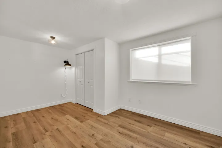 Unfurnished bedroom featuring a closet and light wood-style flooring