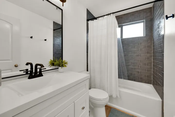 Bathroom featuring shower / bath combo and vanity