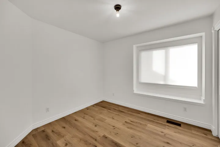 Empty room with light wood finished floors and baseboards