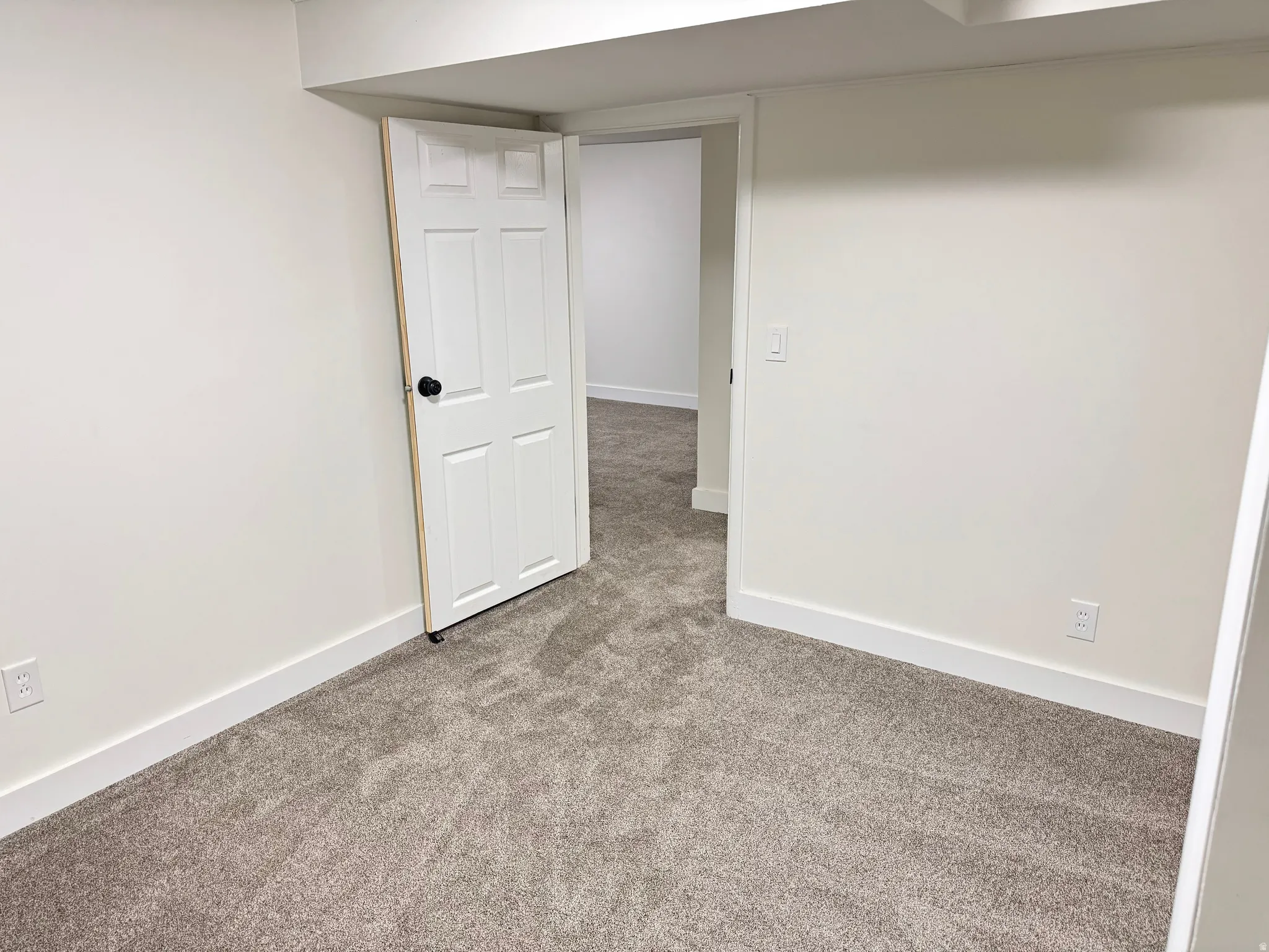 Spare room with baseboards and carpet