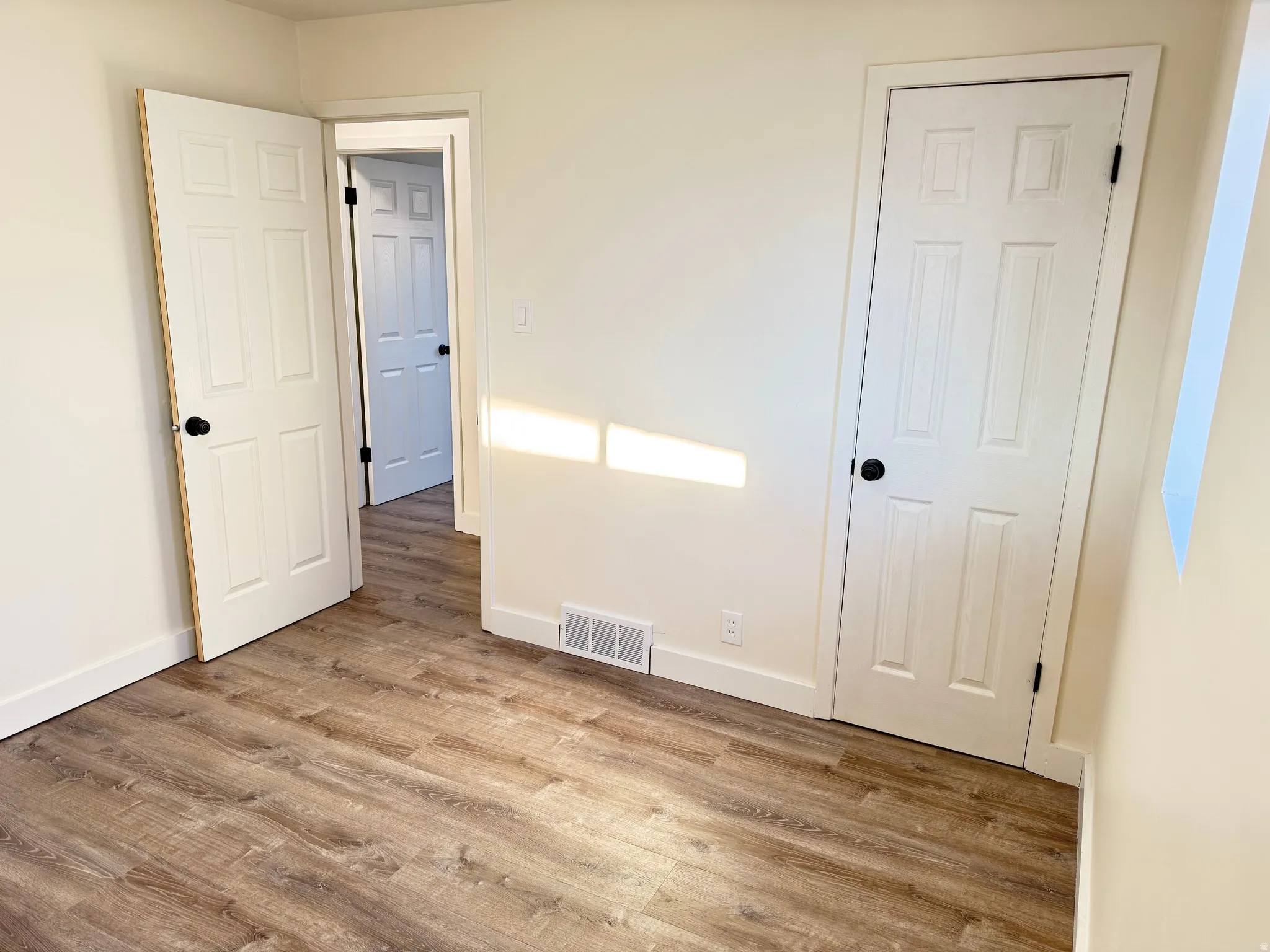 Unfurnished bedroom with light wood-type flooring and baseboards