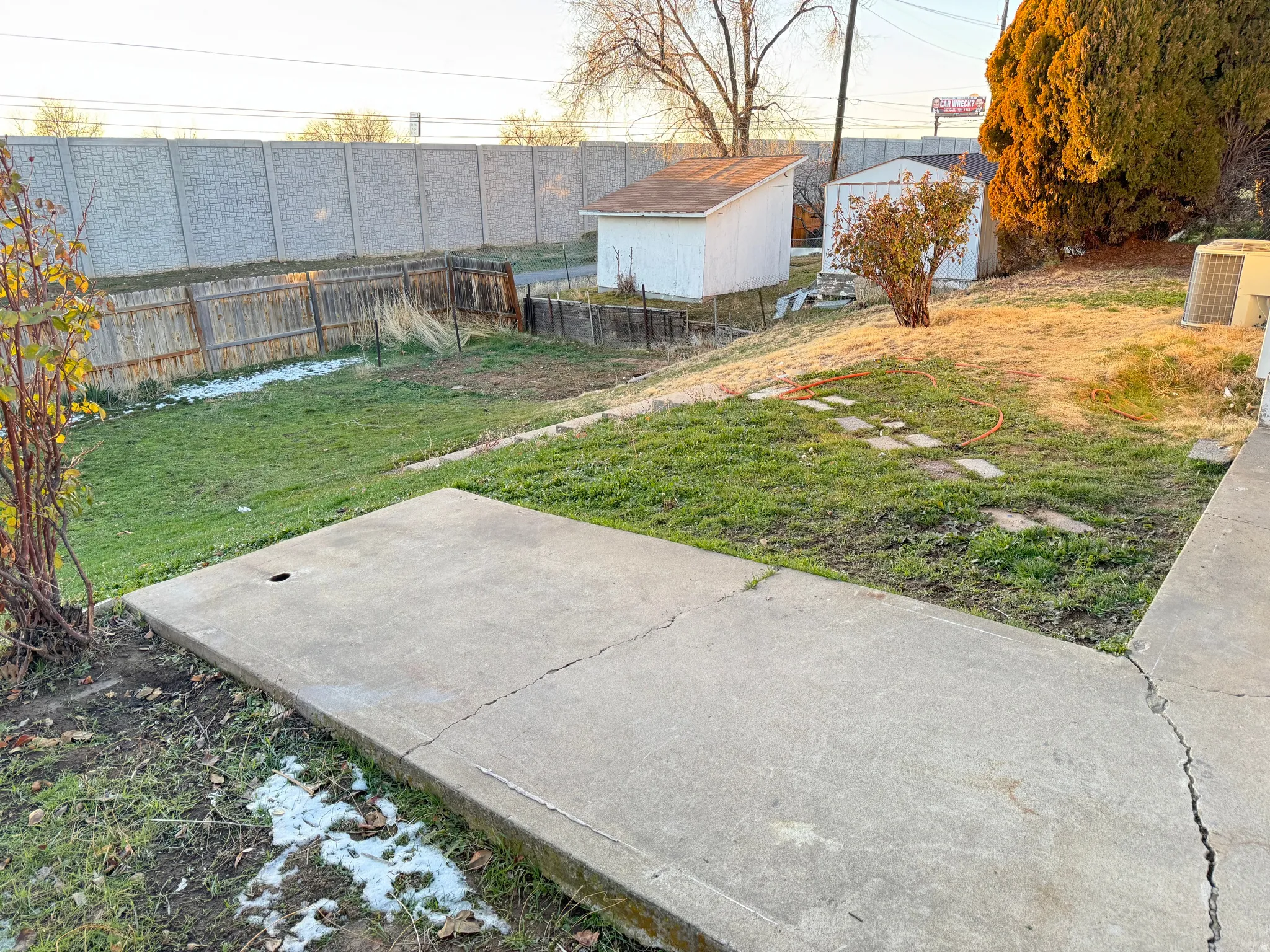Fenced backyard with a patio