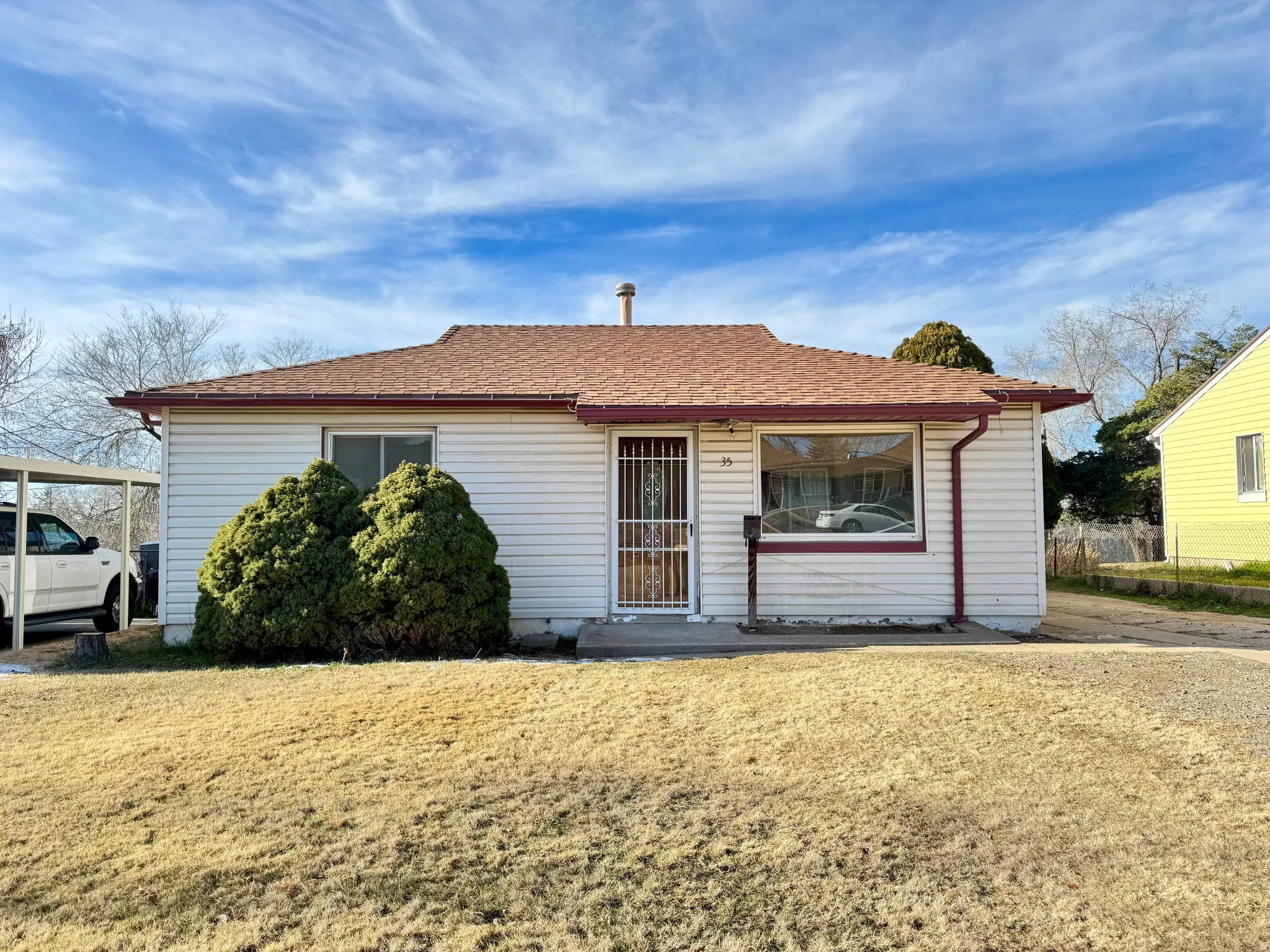 View of front of home featuring a shingled roof and a front yard