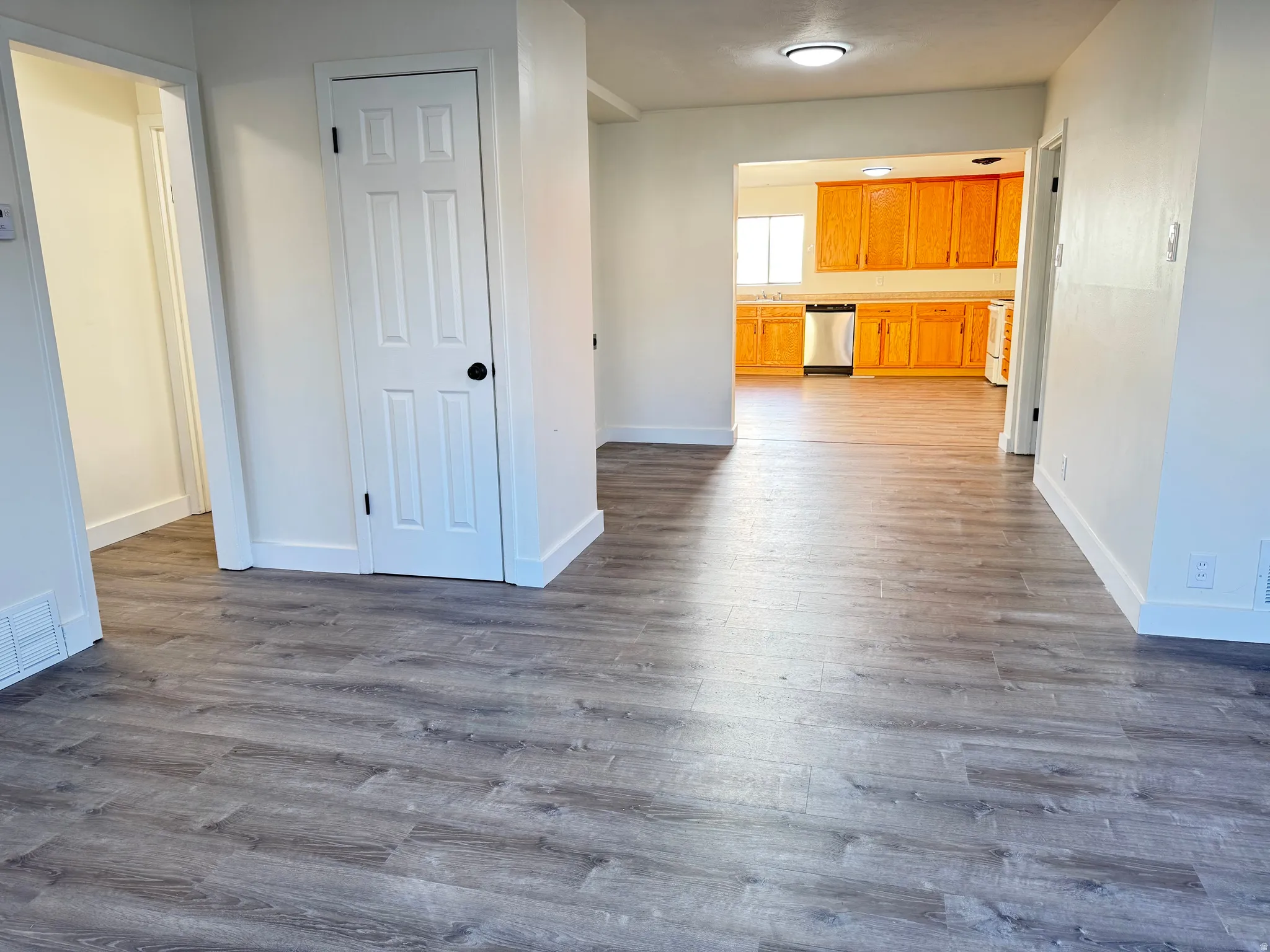 Corridor with dark wood finished floors and baseboards