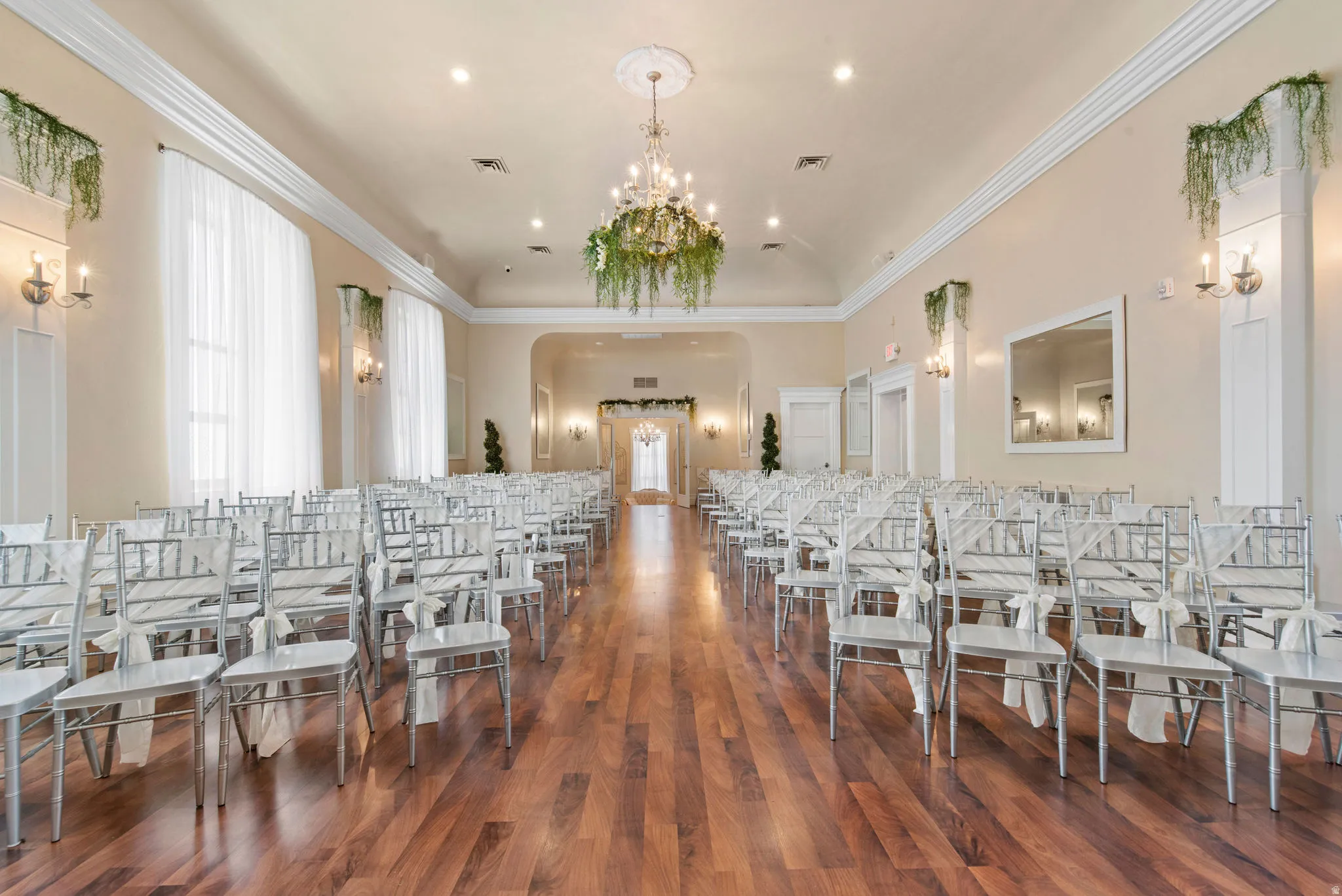 Misc room featuring healthy amount of natural light, recessed lighting, ornamental molding, a chandelier, and arched walkways