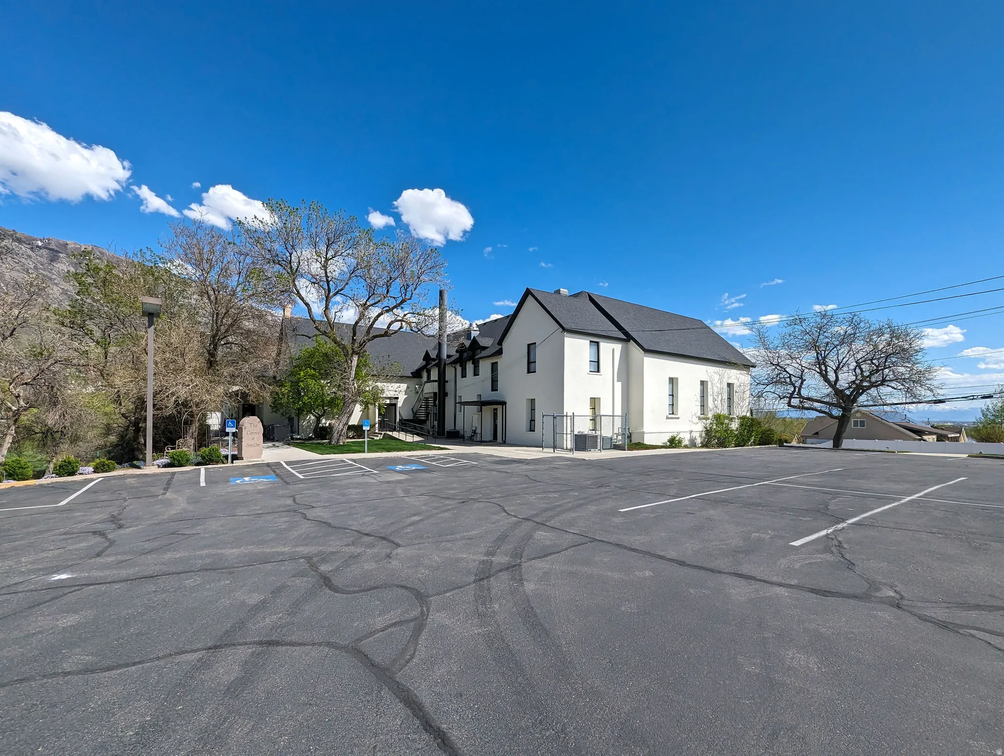 Uncovered parking lot featuring a residential view