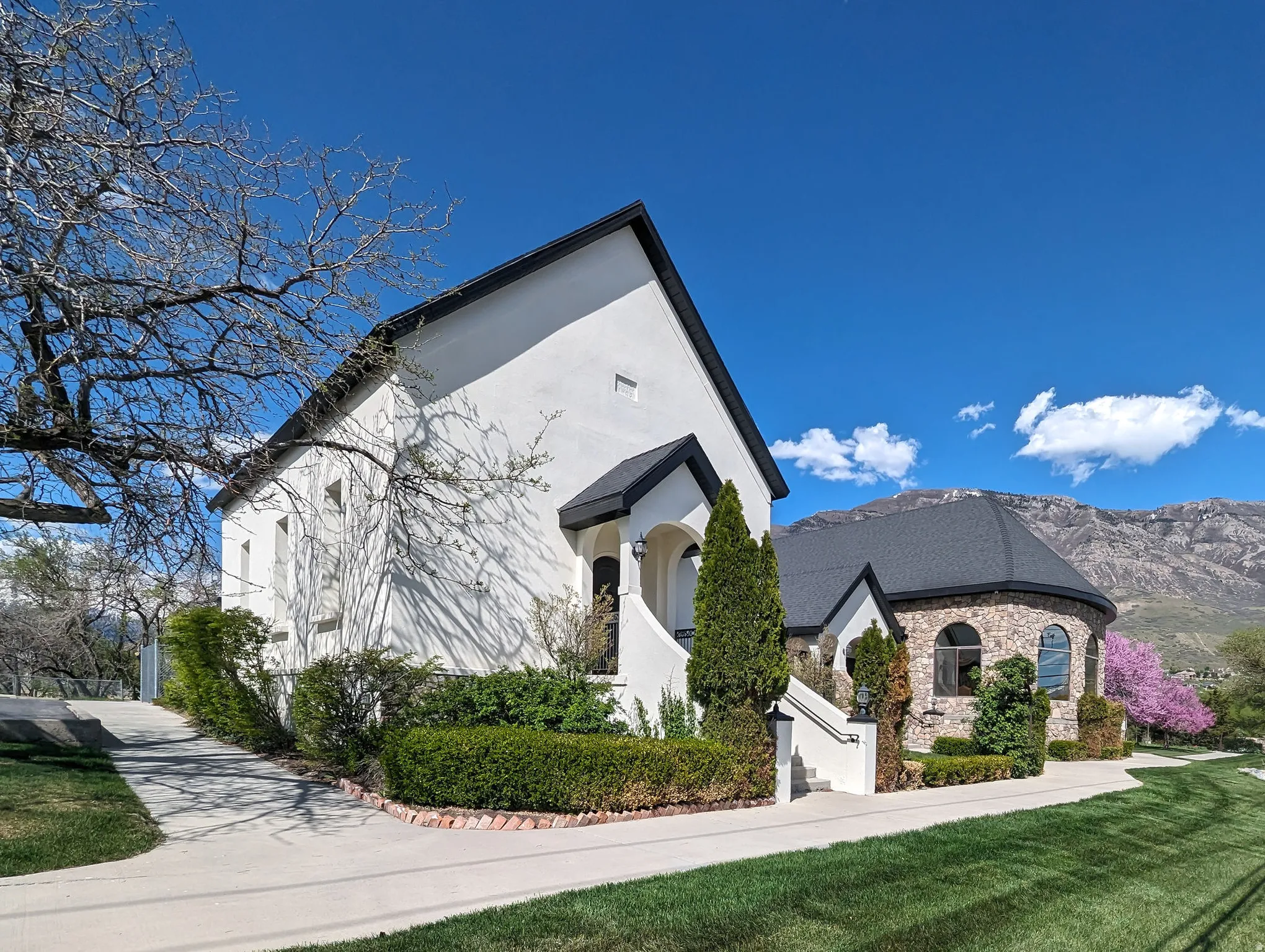 View of front of property with stucco siding, stone siding, and a mountain view