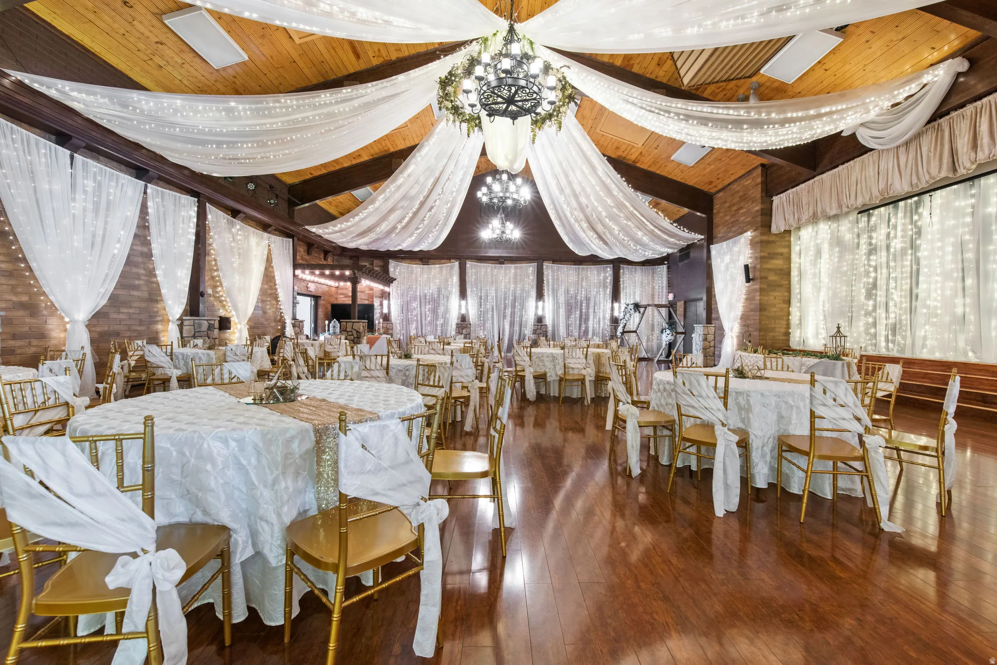 Dining room with a chandelier, wood ceiling, and dark wood-style flooring