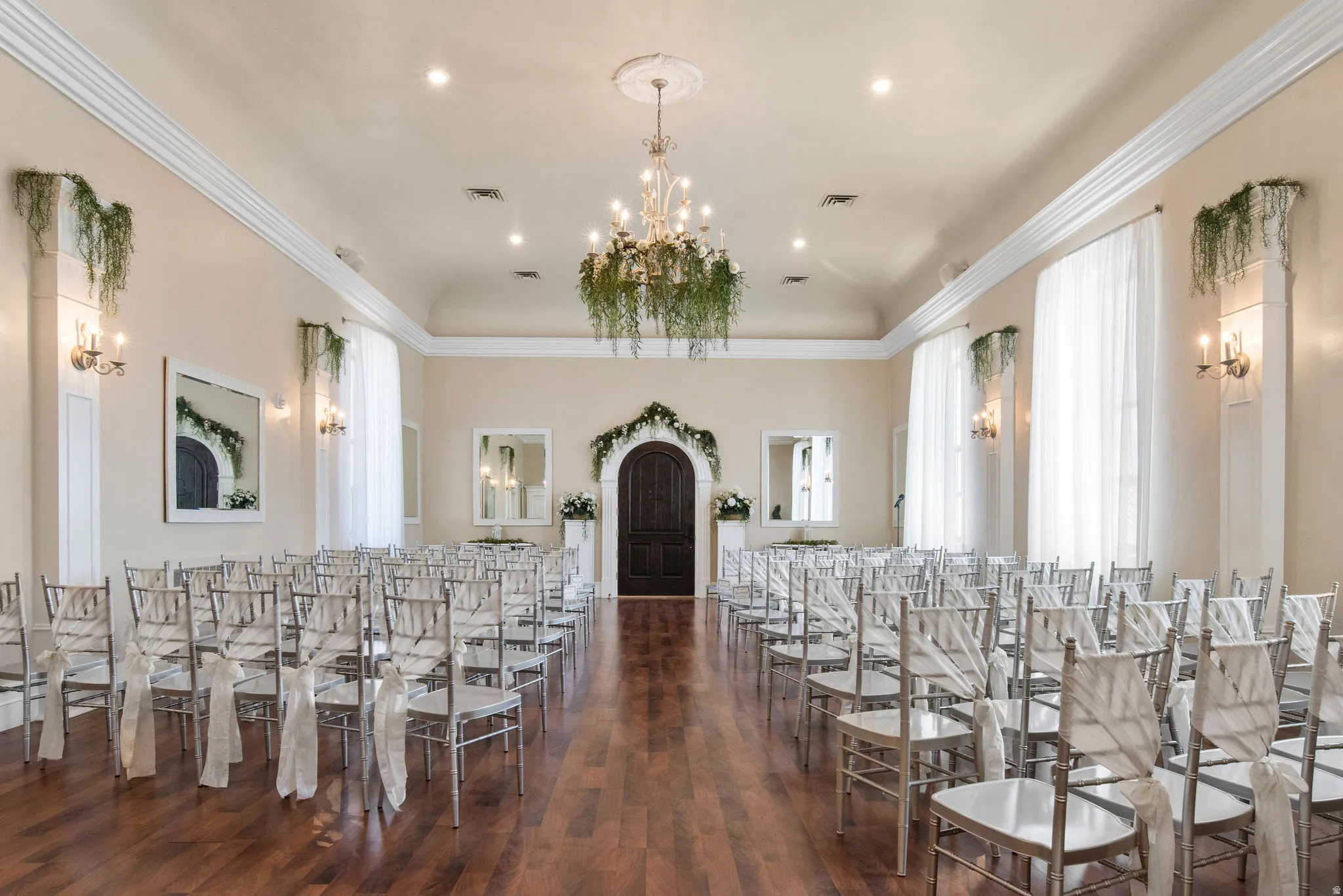 Dining space with dark wood-type flooring, a chandelier, ornamental molding, and recessed lighting