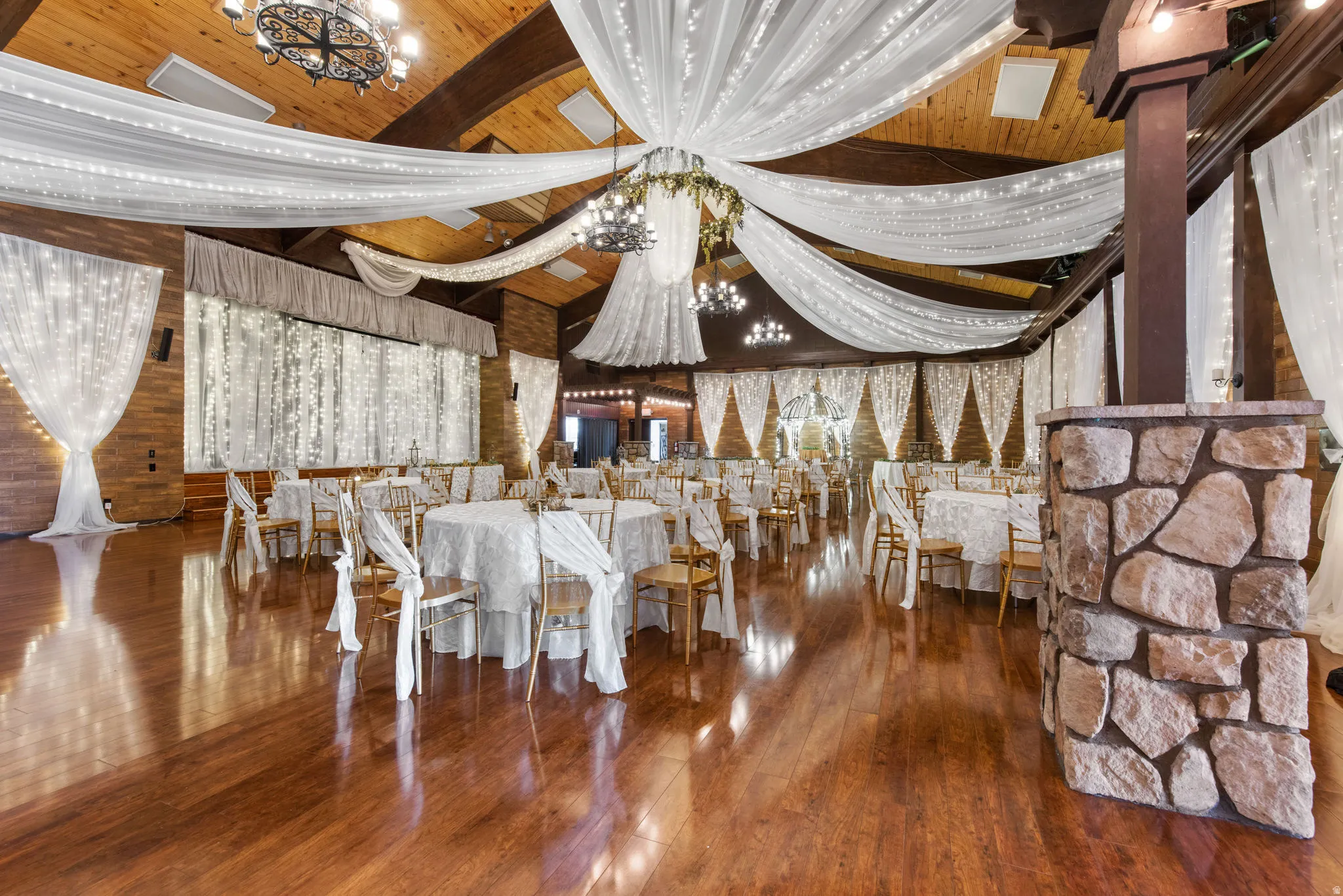 Dining area with a chandelier, beam ceiling, and dark wood finished floors
