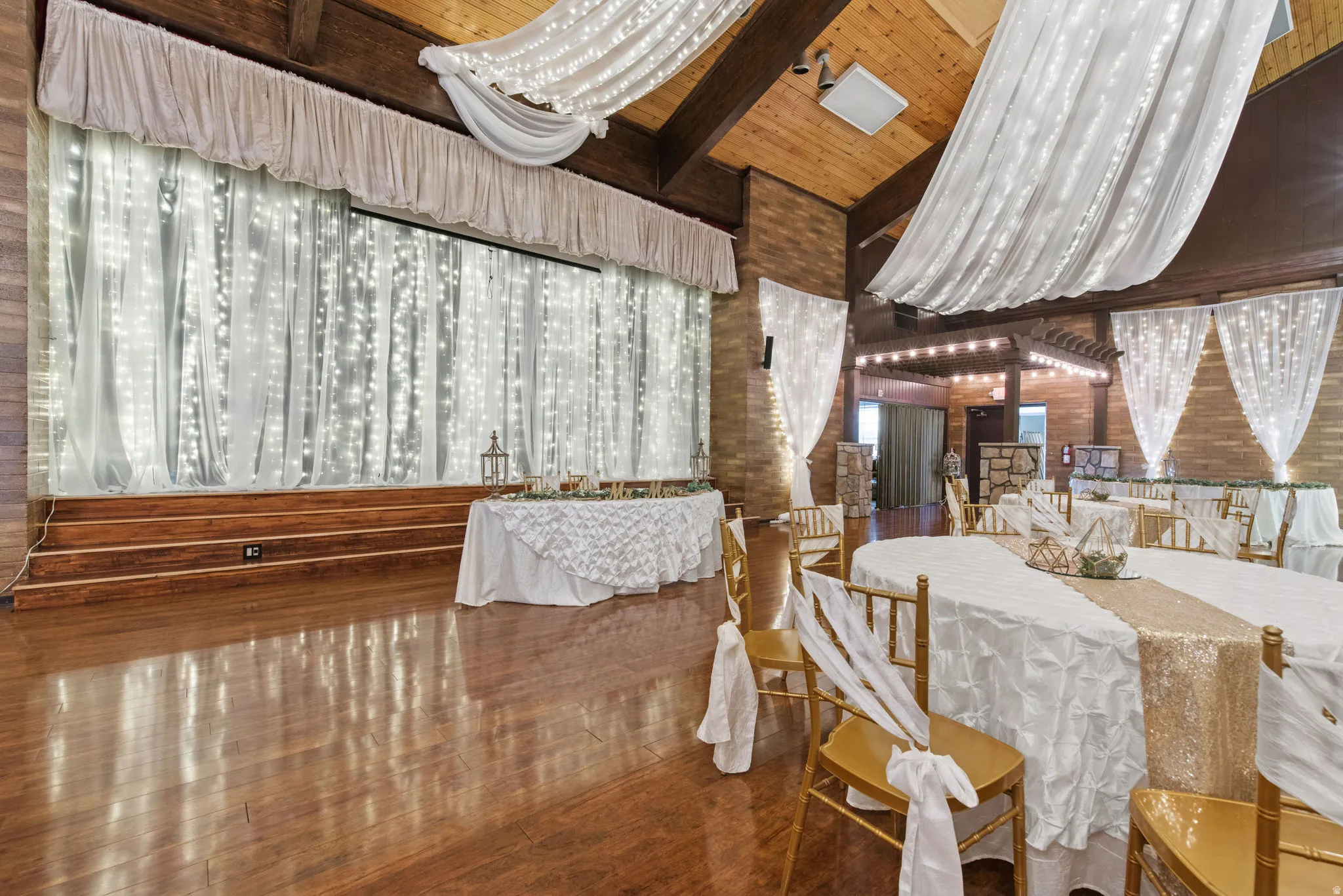 Dining room featuring wood ceiling, wood finished floors, wooden walls, and a chandelier