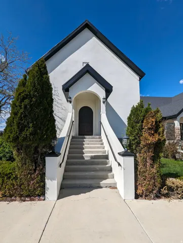View of exterior entry featuring stucco siding